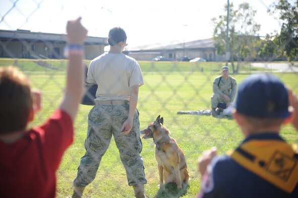 A K-9 demonstration takes place on the softball field at Moody Air Force Base Ga., Oct. 15, 2011. The demonstration was one of five events that showed families how the 23rd Security Force Squadron would react if there was an intruder in a deployed environment. (U.S. Air Force photo by Airman 1st Class Paul Francis/Released)
