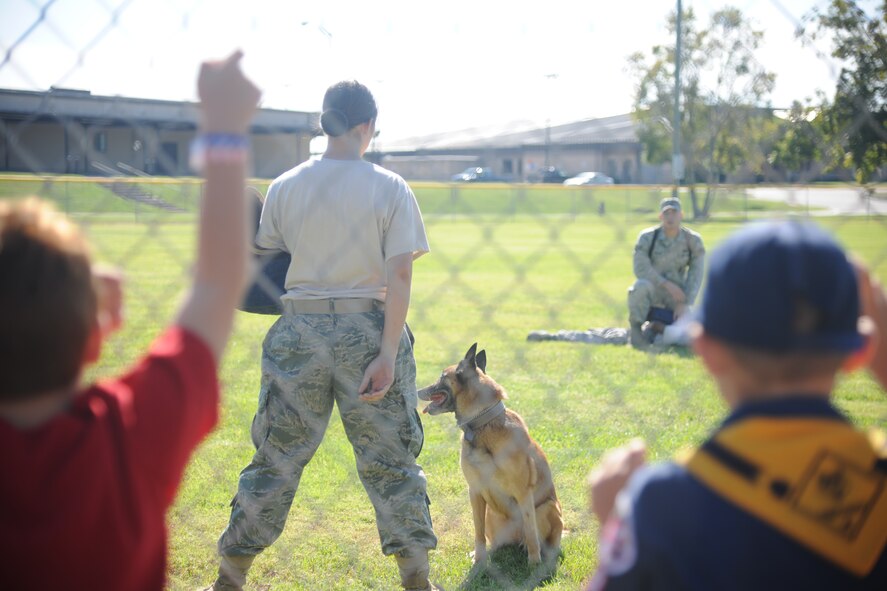 A K-9 demonstration takes place on the softball field at Moody Air Force Base Ga., Oct. 15, 2011. The demonstration was one of five events that showed families how the 23rd Security Force Squadron would react if there was an intruder in a deployed environment. (U.S. Air Force photo by Airman 1st Class Paul Francis/Released)
