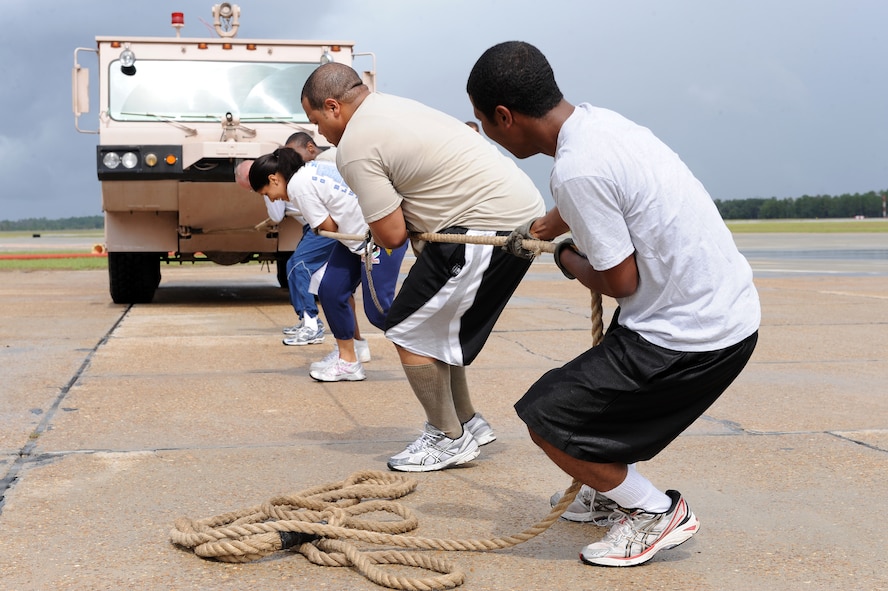 Airmen from the 23rd Fighter Group pull a P-19 fire truck during a Fire Muster Challenge at Moody Air Force Base, Ga., Oct. 11, 2011. The team competed to pull the truck 50 feet as fast as possible. (U.S. Air Force photo by Senior Airman Ciara Wymbs/Released) 