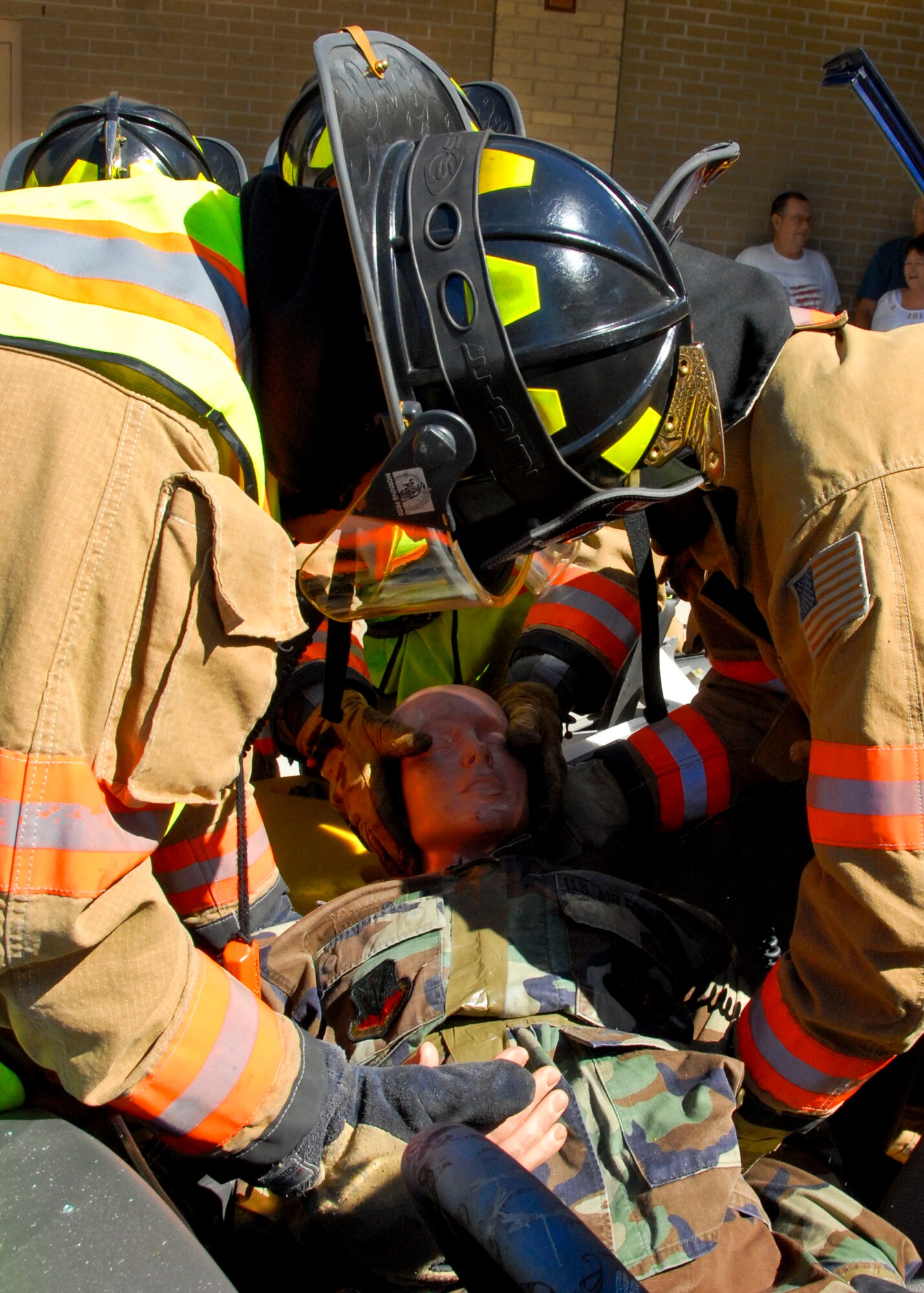 Firefighters from the 96th Civil Engineer Group place an automobile crash ‘victim’ onto a spinal board for hospital transportation, during a ‘Jaws of Life’ demonstration at the base exchange Oct. 14 at Eglin Air Force Base, Fla.  The demonstration simulated how firefighters rescue victims involved in an automobile crash as part of Fire Prevention Week.  (U.S. Air Force photo/Kevin Gaddie)