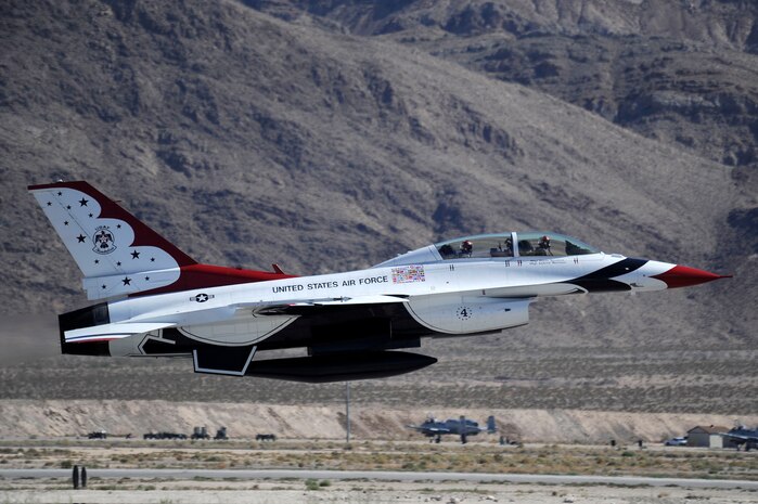 Capt. Nicholas Holmes, Thunderbird 4 slot pilot, and JR Hildebrand, IndyCar driver, take off in an F-16 Fighting Falcon Oct. 11, 2011, at Nellis Air Force Base, Nev. Hildebrand, driver of the number four National Guard car for Panther Racing, came to Las Vegas to compete in the IZOD IndyCar World Championship at the Las Vegas Motor Speedway. (U.S. Air Force photo by Staff Sgt. Larry E. Reid Jr./Released)