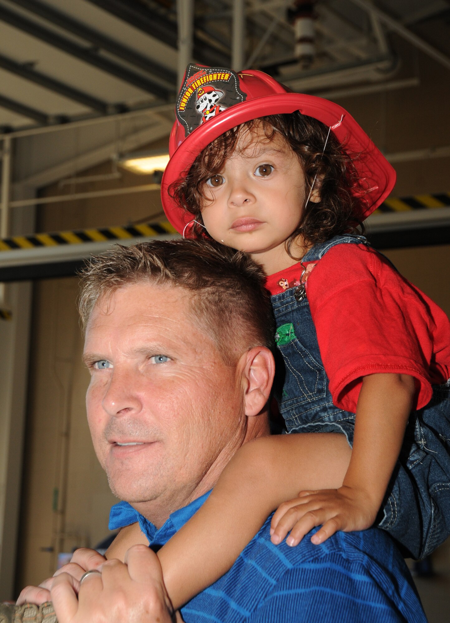 Master Sgt. James Bunce, 81st Dental Squadron, and his son, Jayden, 2, take a stroll during the Keesler Fire Department open house Oct. 15, 2011, Keesler Air Force Base, Miss.  The event was the finale to Fire Prevention Week held Oct. 11-15, 2011.  (U.S. Air Force photo by Kemberly Groue)