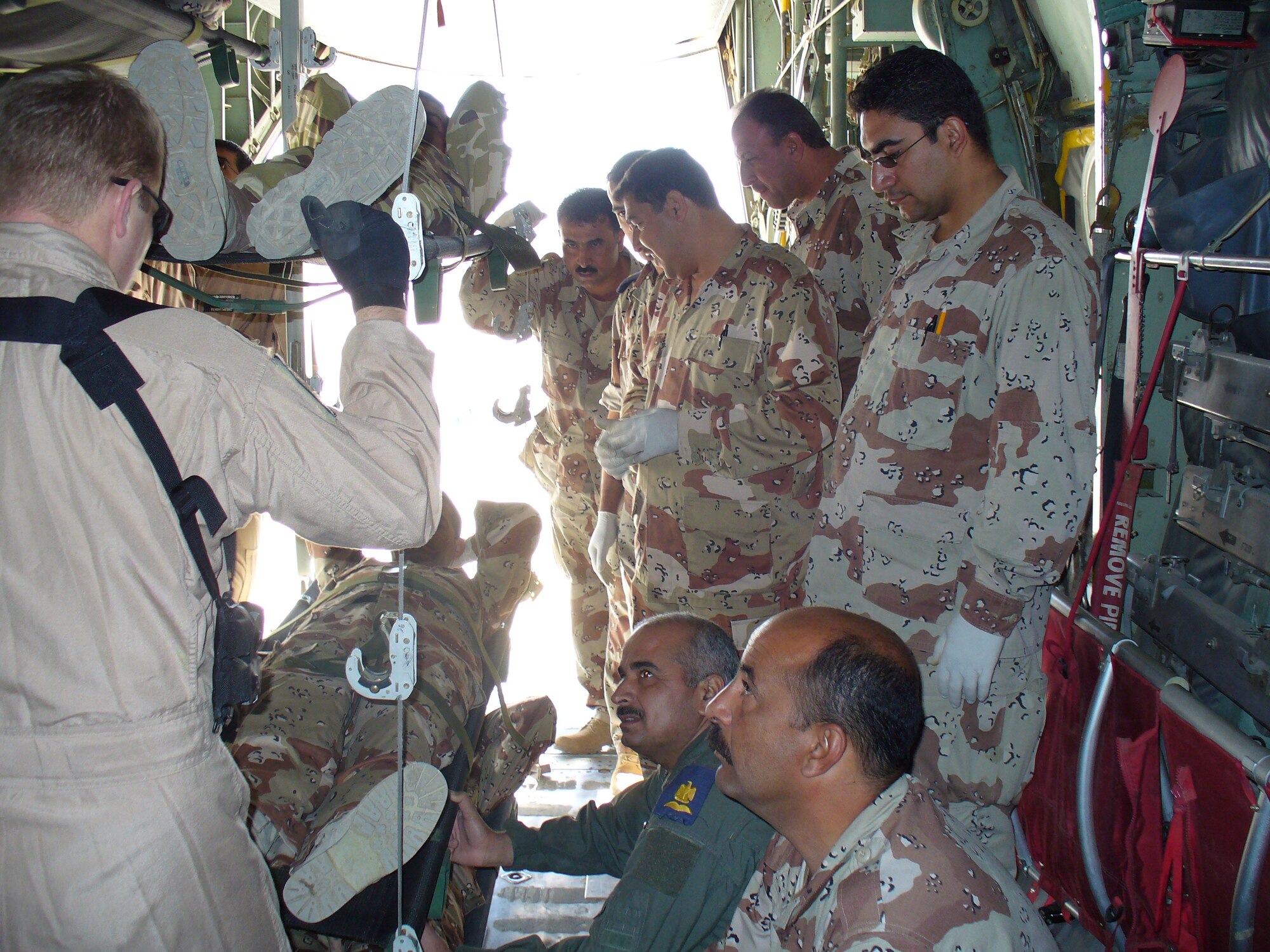 DIMO educators briefing patient safety tips on board an Iraqi Air Force C-130 at New Al Muthana Iraqi Air Force Base, Baghdad, Iraq. (Air Force Courtesy Photo)