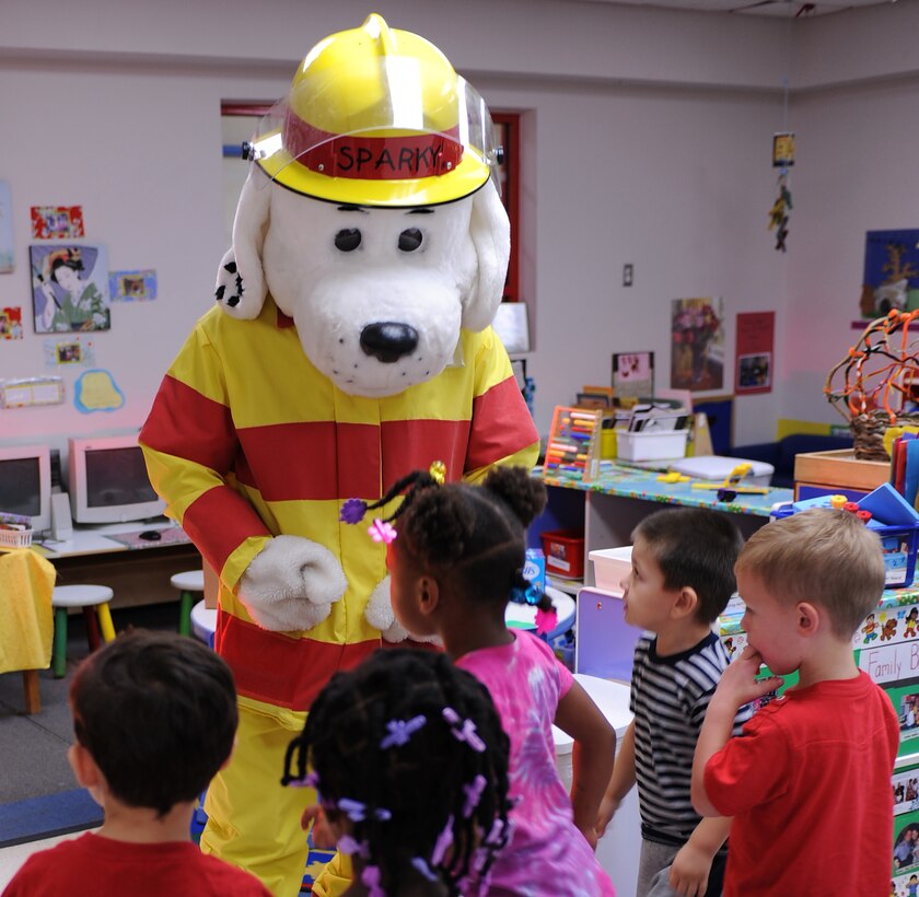 Sparky the Fire Dog dances and sings about fire safety with children at the child development center during National Fire Prevention Week at Langley Air Force Base, Va., Oct. 13, 2011. Sparky celebrated his 60th birthday this year and teaches children about fire safety. (U.S. Air Force photo by Airman 1st Class Teresa Cleveland/Released)