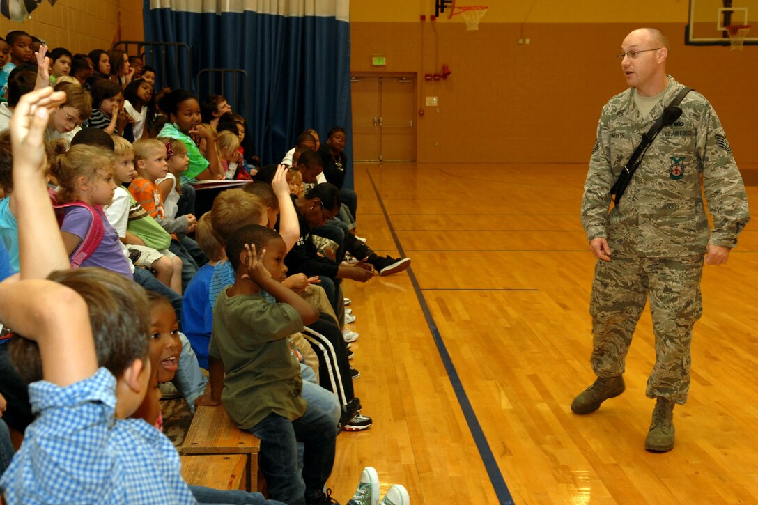 U.S. Air Force Tech. Sgt. Matthew Harless, 633d Civil Engineer Squadron firefighter, talks to children about fire prevention and safety during a National Fire Week assembly at Bethel Manor Youth Center at Langley Air Force Base, Va., Oct. 13, 2011. Harless talked about practicing escape routes with their families and checking smoke detectors often to make sure they work. (U.S. Air Force photo by Staff Sgt. Jeff Nevison/Released)