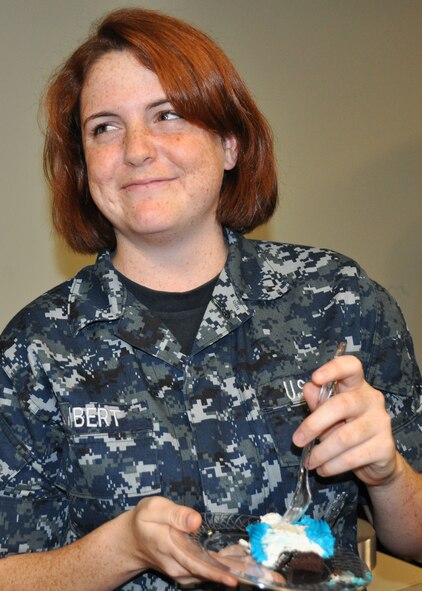 Navy Corpsman Sarah Lambert, a hospital apprentice with the Navy’s F-35 squadron, VFA-101, Strike Fighter Squadron, enjoys some birthday cake celebrating the Navy’s 236th birthday, Oct. 13 at Eglin Air Force Base, Fla.  As the youngest Sailor in her unit at 19, she and the oldest enlisted person in the unit carried on the tradition of cutting the cake. Sailors, Marines and Airmen from the various joint strike fighter units at the 33rd Fighter Wing celebrated the occasion in the squadron’s ready room.  (U.S. Air Force photo/Maj. Karen Roganov)