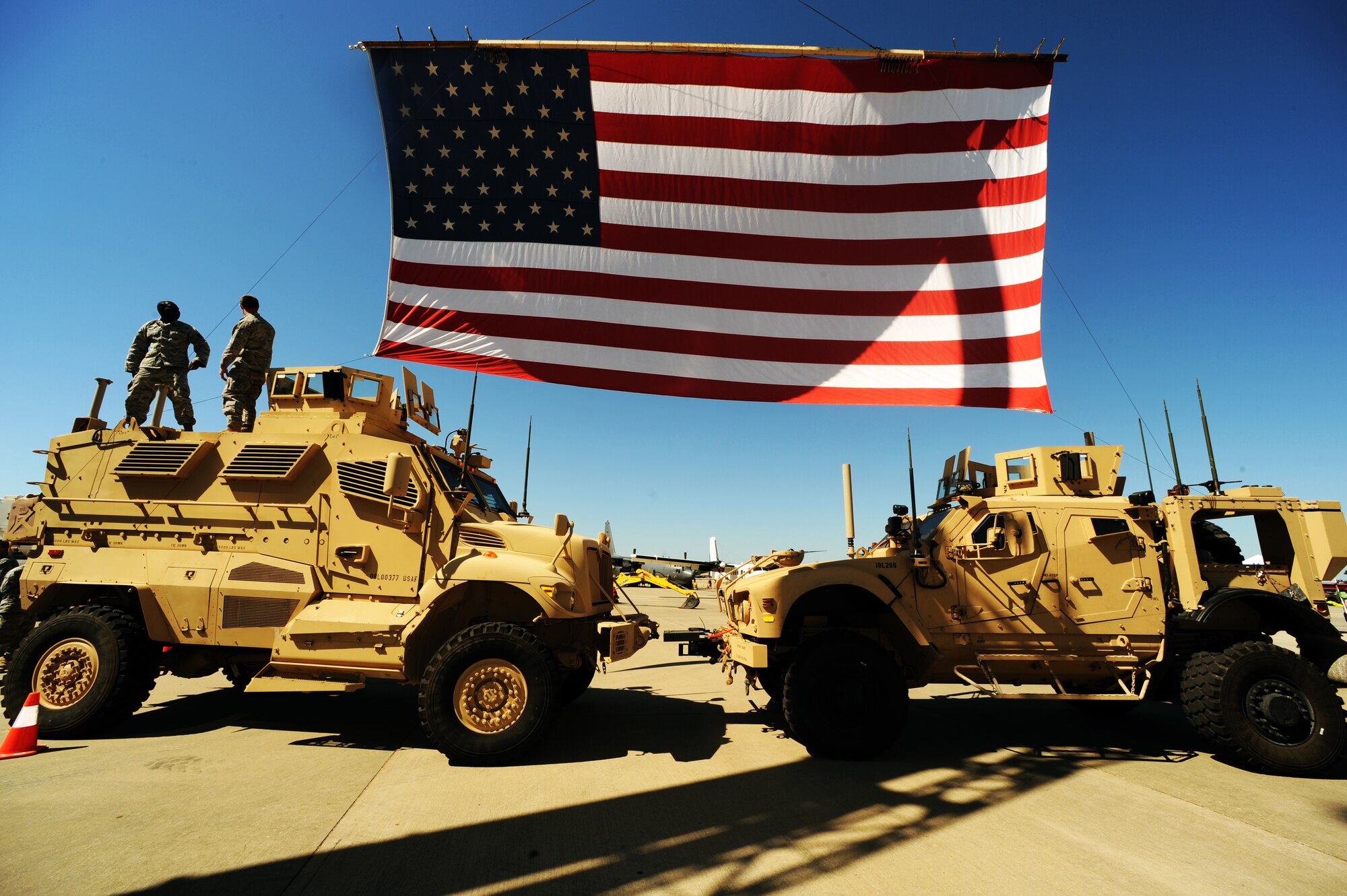 An American flag is displayed over two vehicles at the Fall Festival. The event was held at the Freedom Hangar, Hurlburt Field, Fla., Oct. 15, 2011. The festival included games, informational booths, hands-on vehicle displays and more. (U.S. Air Force photo/Senior Airman Eboni Reams)


