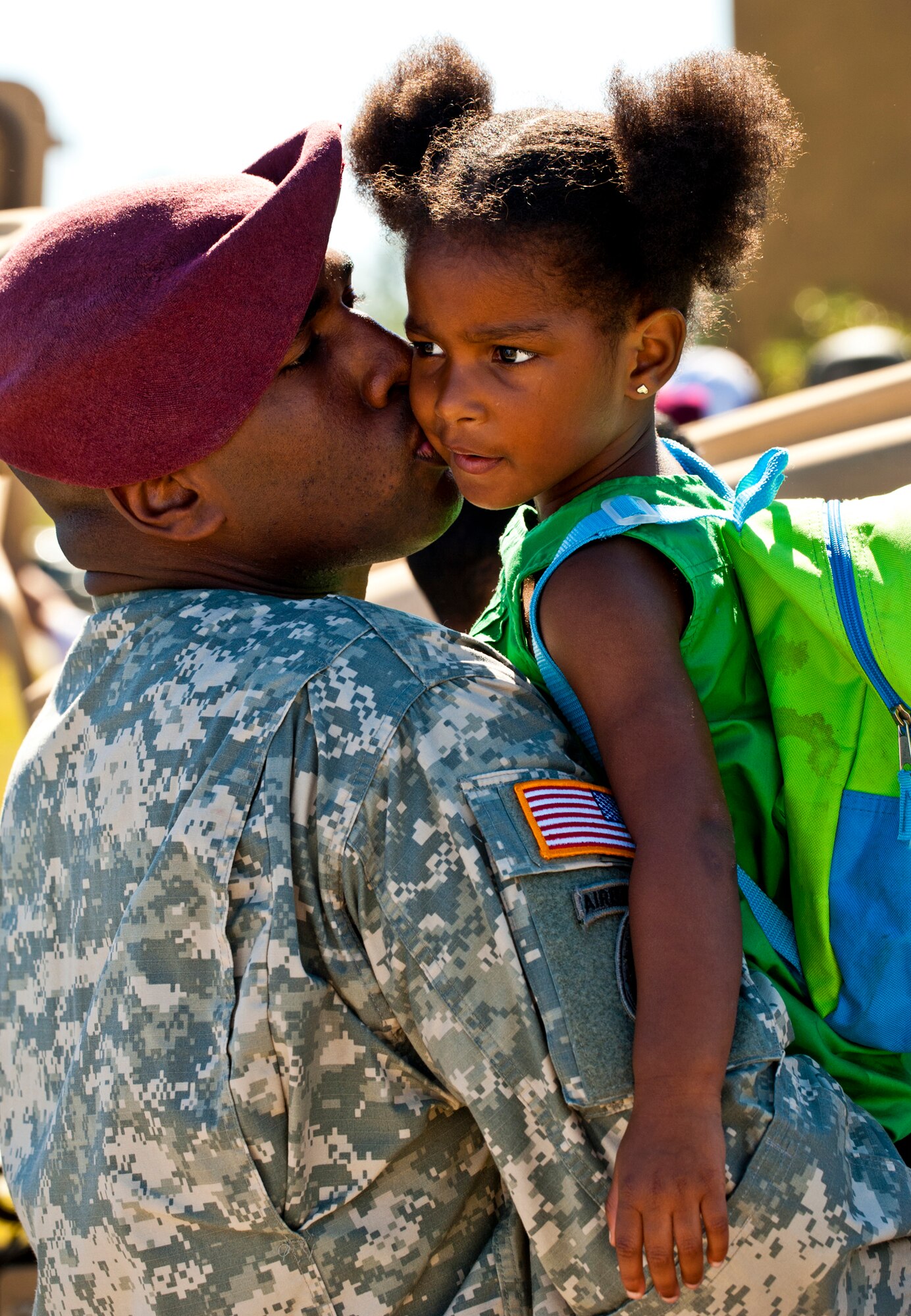 Capt. Luis Etienne, of the 7th Special Forces Group, gives his daughter, Ella-Marie, a kiss during the 7th Special Forces Group's ribbon cutting ceremony and open house Oct. 14.  Attendees toured grounds, got to check out the state-of-the-art equipment and witnessed Army demonstrations.  The open house concluded a six-year journey for the group who left Fort Bragg, N.C., as a result of the 2005 Base Realignment and Closure process.  (U.S. Air Force photo/Samuel King Jr.)