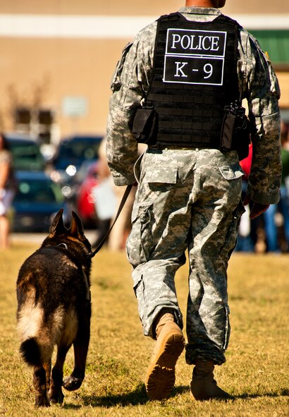 An Army K-9 unit patrols the grounds during the 7th Special Forces Group's ribbon cutting ceremony and open house Oct. 14.  Attendees toured grounds, got to check out the state-of-the-art equipment and witnessed Army demonstrations.  The open house concluded a six-year journey for the group who left Fort Bragg, N.C., as a result of the 2005 Base Realignment and Closure process.  (U.S. Air Force photo/Samuel King Jr.)