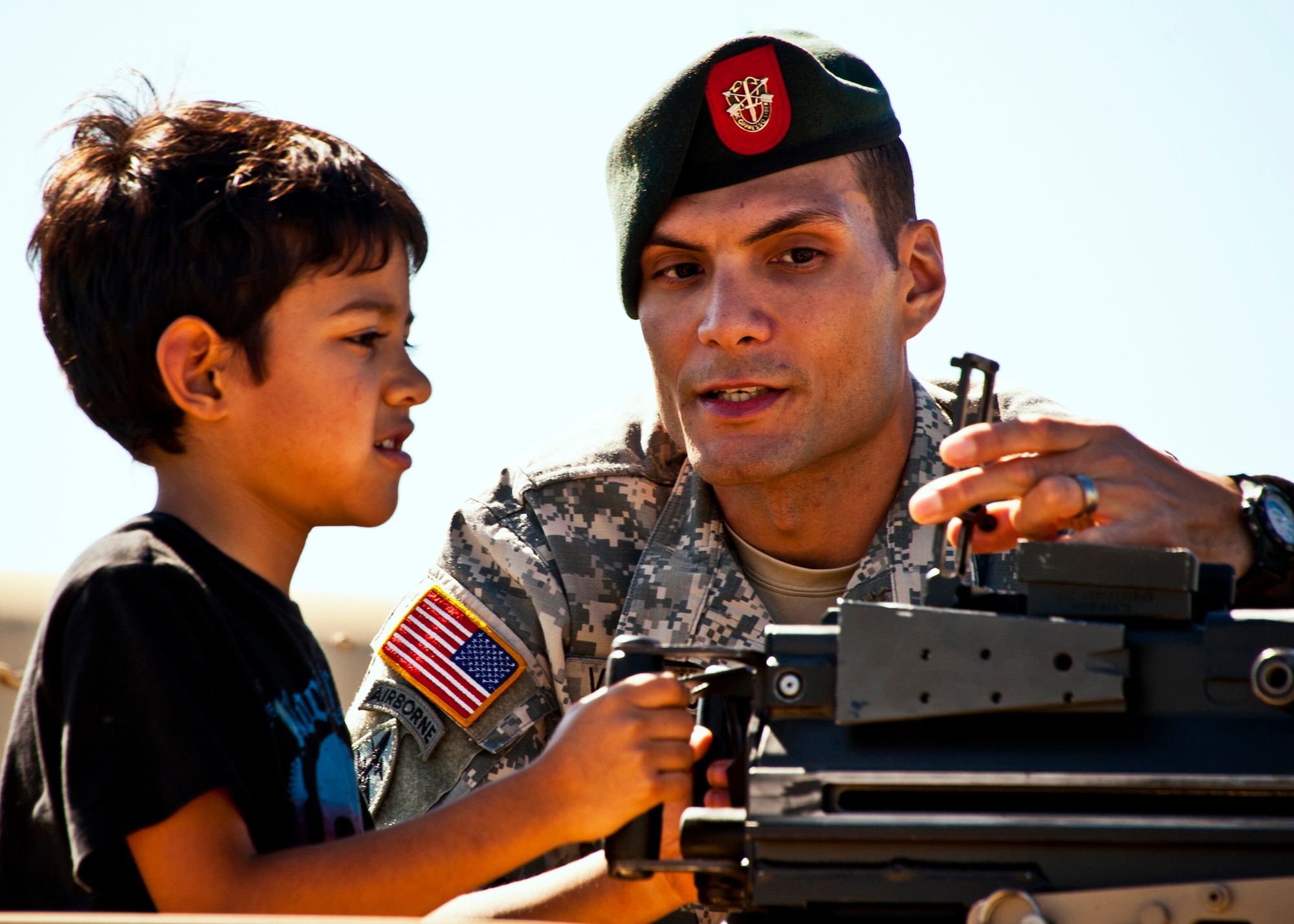 Staff Sgt. Joseph Villanueva, of the 7th Special Forces Group, explains the site on a Humvee turret to a potential Soldier at the 7th SFG ribbon cutting ceremony and open house Oct. 14.  Attendees toured grounds, got to check out the state-of-the-art equipment and witnessed Army demonstrations.  The open house concluded a six-year journey for the group who left Fort Bragg, N.C. as a result of the 2005 Base Realignment and Closure process.  (U.S. Air Force photo/Samuel King Jr.)