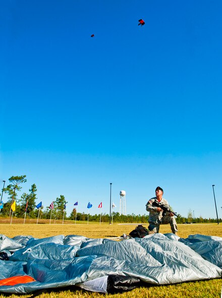 Sgt. 1st Class Gordy Horvath, a member of the Black Daggers demonstration team, watches as his teammates drift down to the parade field to begin the 7th Special Forces Group's ribbon cutting ceremony and open house Oct. 14.  After the ceremony, attendees toured grounds, got to check out the state-of-the-art equipment and witnessed Army demonstrations.  The open house concluded a six-year journey for the group who left Fort Bragg, N.C. as a result of the 2005 Base Realignment and Closure process.  (U.S. Air Force photo/Samuel King Jr.)