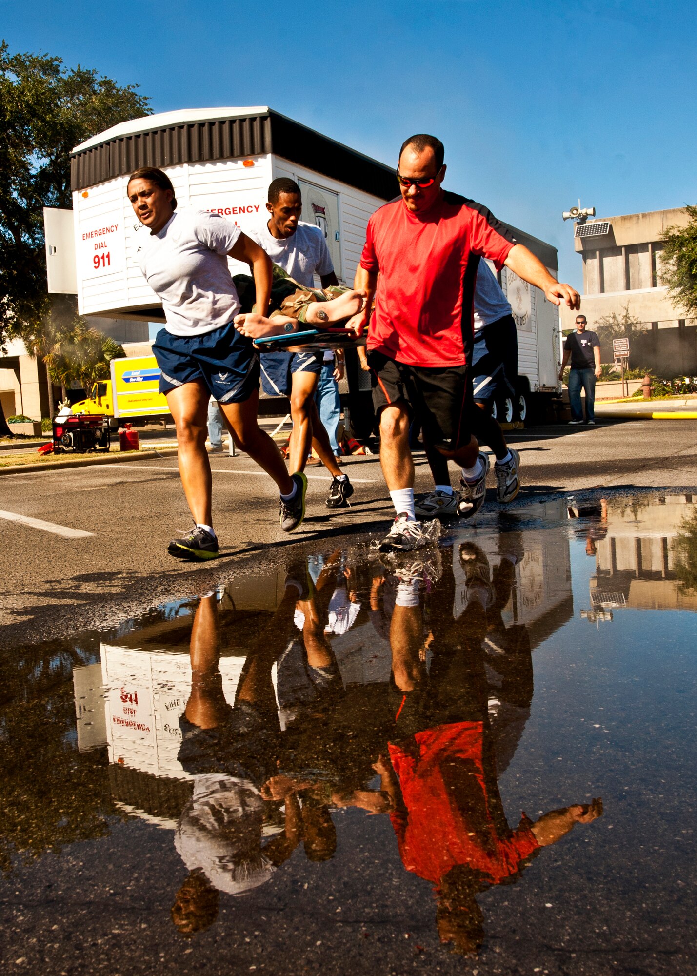 A Fire Muster Challenge team quickly moves a litter toward the finish line during the fourth round of this year's competition Oct. 14 at Eglin Air Force Base, Fla.  The competition concluded Eglin fire department's Fire Prevention Week campaign.  (U.S. Air Force photo/Samuel King Jr.)