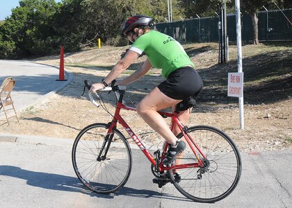 A cyclist peddles by during Rambler 120, hosted by Joint Base San Antonio, at Canyon Lake, Texas. The annual event is a cycling, rowing and running endurance competition. (U.S. Air Force photo/Dave Terry)