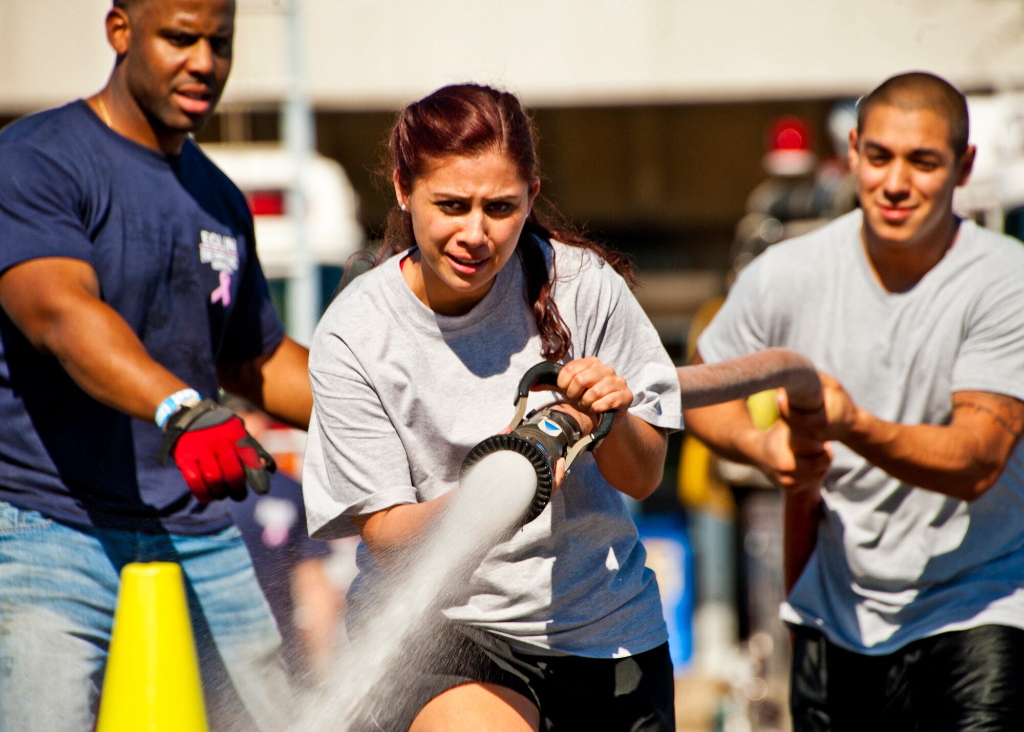 A Fire Muster Challenge contestant aims the fire hose at her target during the fourth round of this year's competition Oct. 14 at Eglin Air Force Base, Fla.  The competition concluded Eglin fire department's Fire Prevention Week campaign.  (U.S. Air Force photo/Samuel King Jr.)
