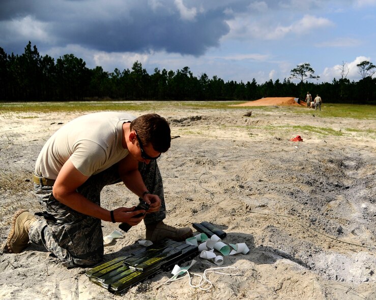 U.S. Air Force Staff Sgt. Brian Dunnagan, explosive ordinance disposal craftsman from 1st Special Operations Civil Engineer Squadron, stacks C-4 explosives at the range on Hurlburt Field, Fla., Sept. 27, 2011.  EOD personnel participate in this type of field training exercise at least twice a quarter to ensure that they receive proper hands-on experience with ordinance. (U.S. Air Force photo/Airman Gustavo Castillo)(Released)
