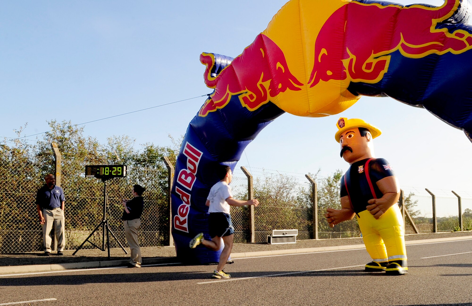 RAF MILDENHALL, England – Firefighter Gary waits at the finish line to congratulate Team Mildenhall members after finishing the Fire Prevention Week fun run here Oct. 14, 2011. This year’s slogan was ‘Protect your family from fire!’ The slogan emphasized the importance of having a fire evacuation plan and fire safety awareness in each home to help ensure safety and prevent casualties. (U.S. Air Force photo/Senior Airman Ethan Morgan)