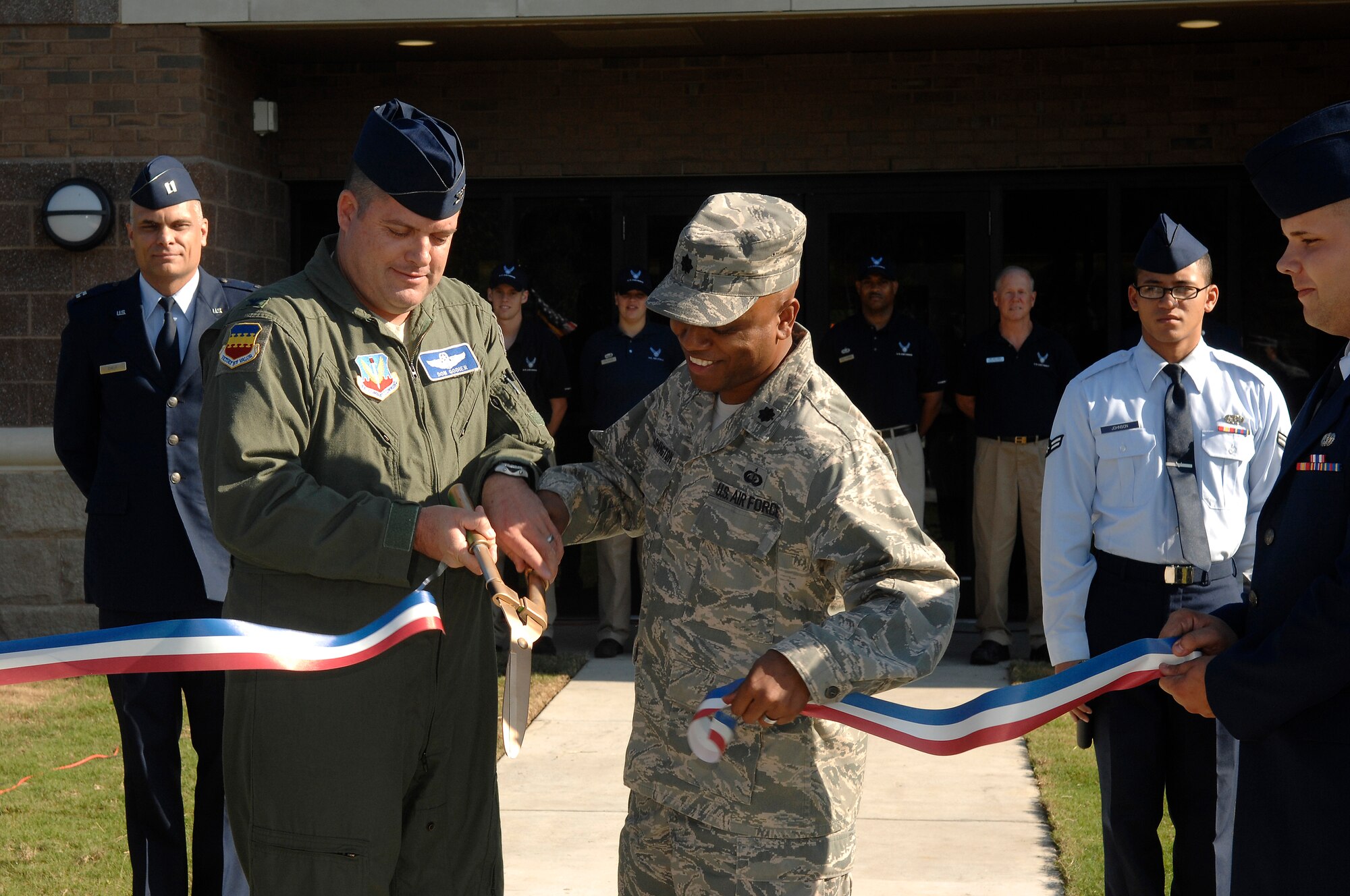 U.S. Air Force Col. Don Godier, 20th Fighter Wing vice commander, (left) and Lt. Col. Dailian Washington, 20th Force Support Squadron commander, cut the ribbon to officially open the new fitness center annex at Shaw Air Force Base, S.C., Oct. 14, 2011. The new fitness center provides additional space and equipment to accommodate the influx of 3rd Army personnel. (U.S. Air Force photo by Airman First Class Hunter Brady/Released)