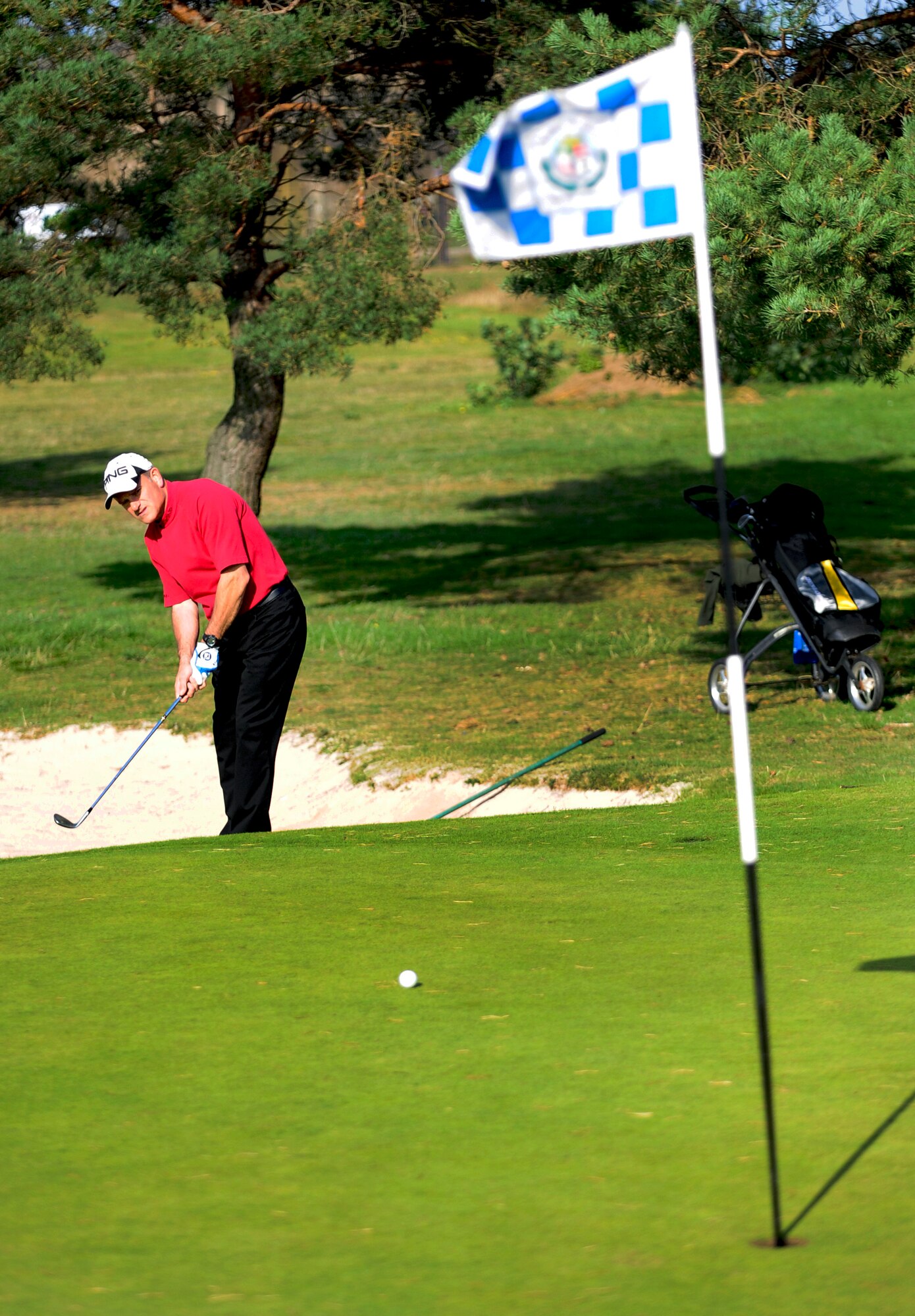 RAF LAKENHEATH, England – Colin Aves chips on to the fourth green during the inaugural British-American Committee ‘Challenge Cup’ held at Breckland Pines Golf Club, RAF Lakenheath, Oct. 14, 2011. Colin represented the British team who won the cup 7-4. (U.S. Air Force photo/Senior Airman Ethan Morgan)