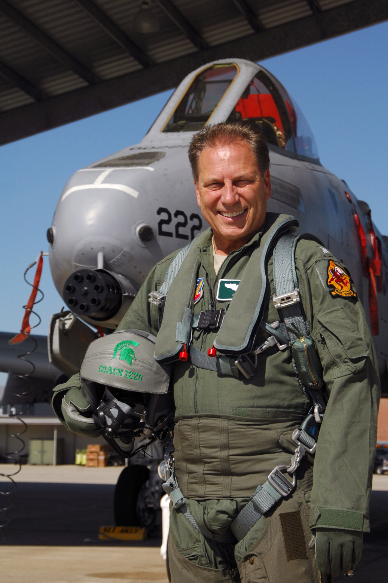 Michigan State University men’s basketball coach Tom Izzo stands in front of an A-10 Thunderbolt II aircraft at Selfridge Air National Guard Base, Mich. Oct. 6, 2011. MSU’s basketball team opened the season with a military theme during the annual “Midnight Madness” session, which marked the first time the team could begin official practices for the season. During the Oct. 14 event at MSU, Izzo entered the school’s Breslin Center basketball arena decked out in flight gear and riding in a small miniature F-16, provided by the 339th USAF Recruiting Squadron. During his trip to Selfridge, Izzo met with local Airmen and was given an orientation of the capabilities of the A-10, which is flown by the Michigan Air National Guard at Selfridge. (U.S. Air Force photo by John S. Swanson)