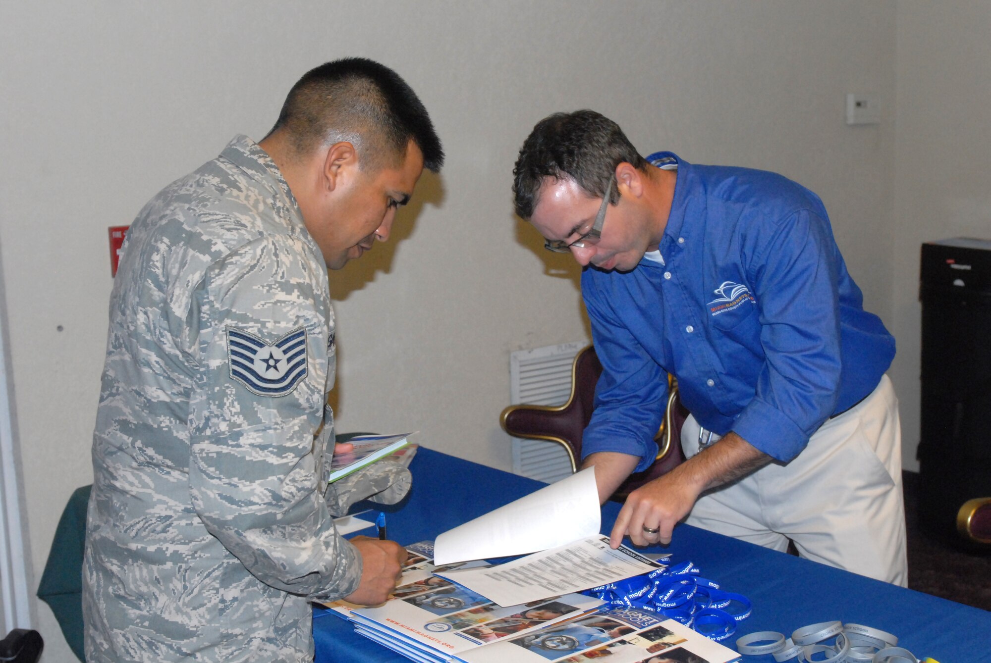 Air Force Tech Sgt. Miguel Gavilan, assigned to Special Operations Command South’s personnel section, speaks with a school representative from Miami-Dade County’s various magnet programs during the Miami-Dade County Expo and Curricular Fair held at Homestead Air Reserve Base, Fla., Oct 12. Gavilan attended the expo to learn about programs, which will benefit his 4-year-old son.
(Department of Defense Photo by Sgt. 1st Class Alex Licea, Special Operations Command South Public Affairs)
