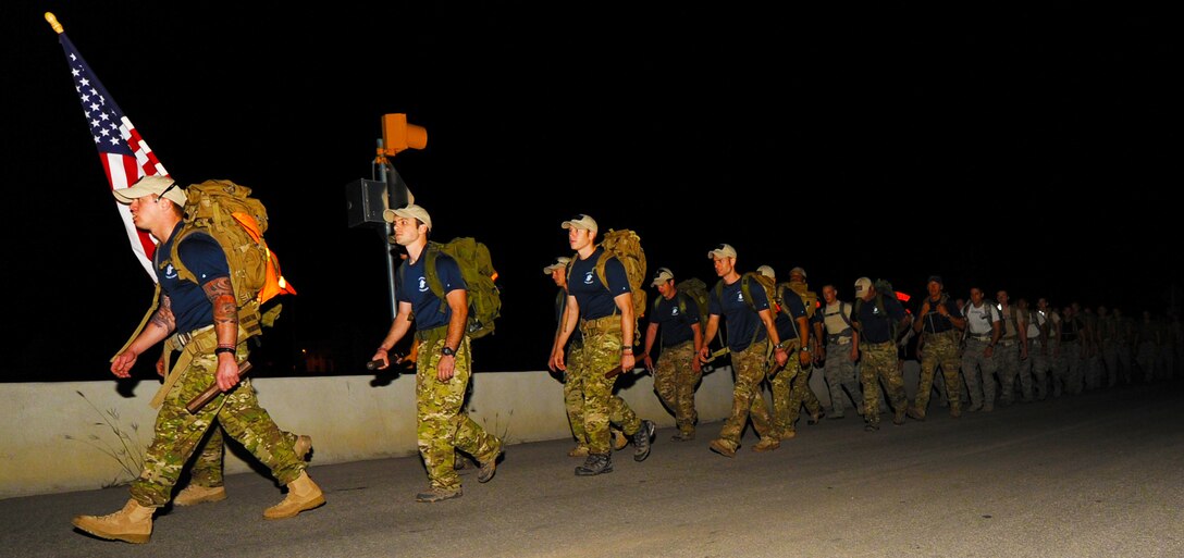 Special tactics Airmen, carrying 50-pound rucksacks on a memorial march honoring their fallen comrades, depart Lackland Air Force Base, Texas, Oct. 16, 2011. The 812-mile march, known as the Tim Davis Memorial March, will span across five states and consists of six teams marching relay style 24 hours a day. (U.S. Air Force photo by Staff Sgt. Sharida Jackson)
