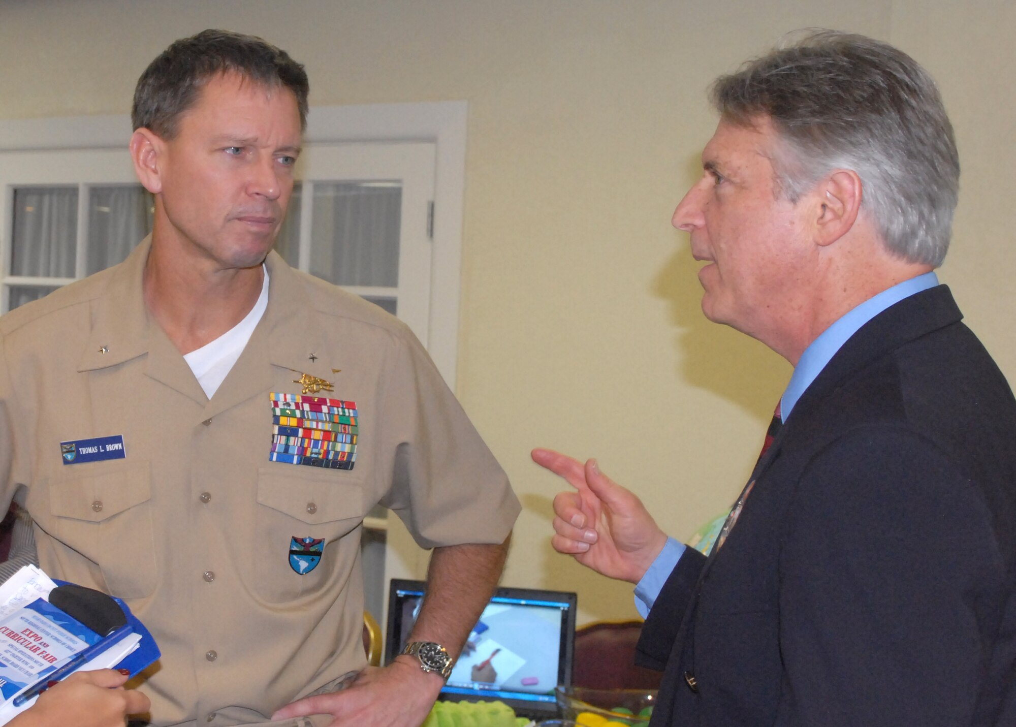 Left to right: U.S. Navy Rear Admiral Thomas L. Brown II, the commander of Special Operations Command South, speaks with Dr. Larry Feldman, the vice chair for the school board of Miami-Dade County, during the Miami-Dade County Expo and Curricular Fair held at Homestead Air Reserve Base, Fla., Oct 12. Brown thanked Dr. Feldman, his staff, and all the school administrators for their participation for the event and continued support to military families across South Florida.   
(Department of Defense Photo by Army Sgt. 1st Class Alex Licea, Special Operations Command South Public Affairs)