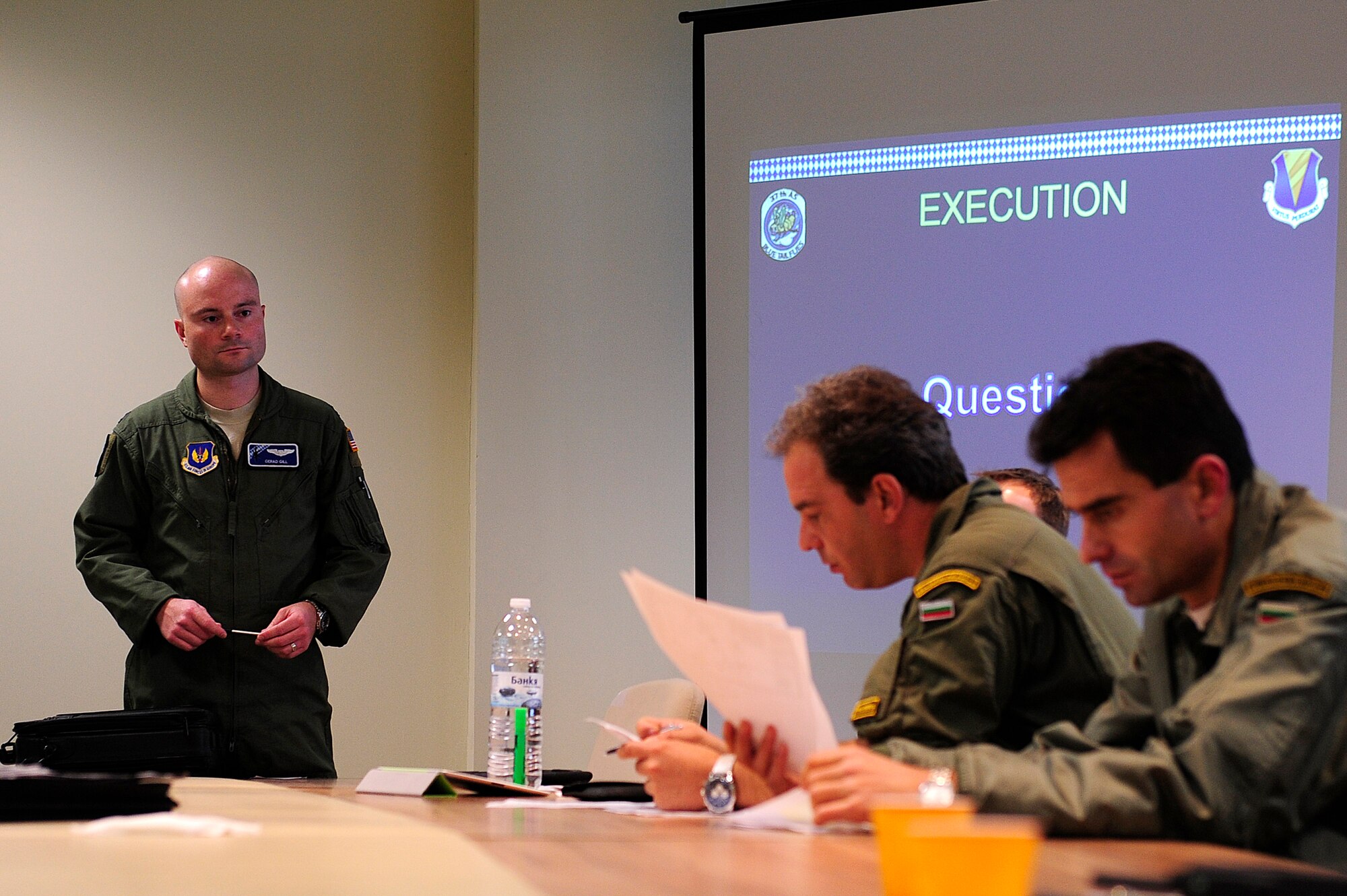 Capt. Gerad Gill, 37th Airlift Squadron pilot from Ramstein Air Base, Germany, briefs Bulgarian aircrew members during Exercise Thracian Fall 2011 in Plovdiv, Bulgaria, Oct. 17, 2011. Thracian Fall is an off-station training exercise designed to enhance interoperability between U.S. and Bulgarian Air Forces as well as build partnerships with paratroopers from both. (U.S. Air Force photo by Senior Airman Stephen J. Otero)