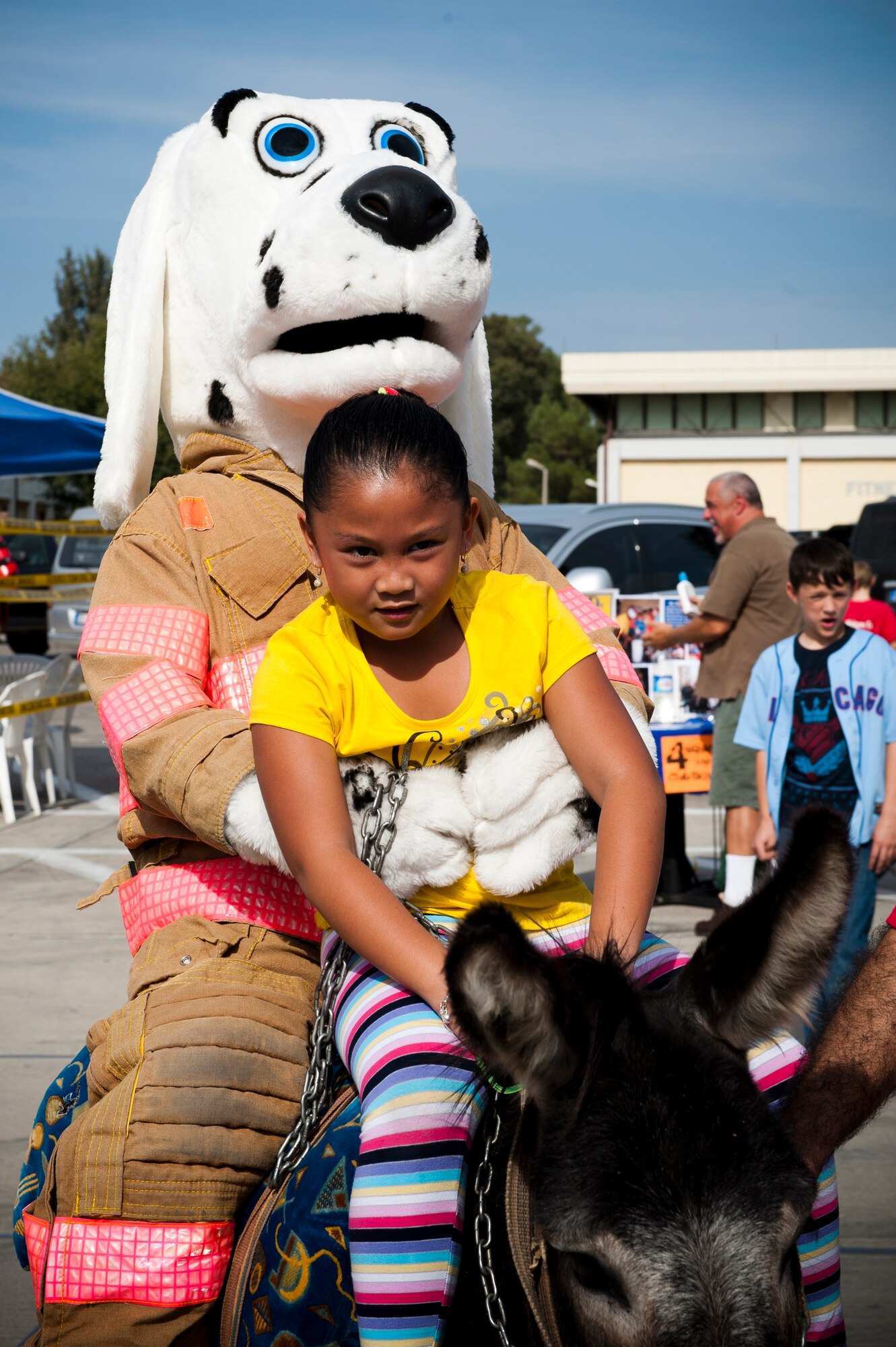 Sparky, the official mascot of the National Fire Protection Association, rides a donkey with a child during the annual Fall Fest Oct. 15, 2011, at Incirlik Air Base, Turkey. The event was hosted by the 39th Force Support Squadron and includes a variety of food, activities and base organization booths. (U.S. Air Force photo by Senior Airman Anthony Sanchelli/Released)