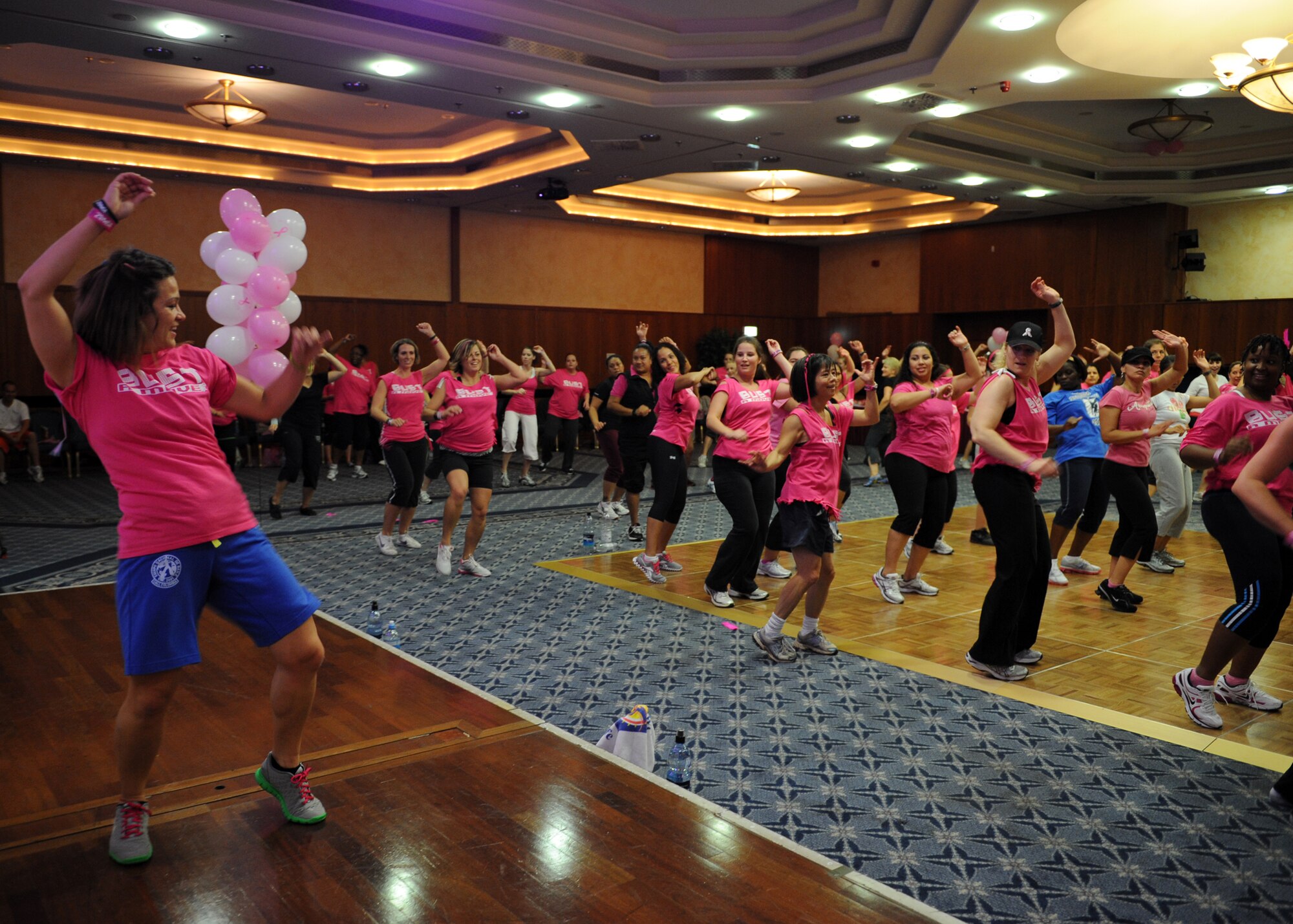 SPANGDAHLEM AIR BASE, Germany – Fiona Cook, wife of Master Sgt. Teddy Cook, 372 Training Squadron Detachment 17, leads the more than 130 participants during a dance at the Zumba for a Cure event in support of Breast Cancer Awareness Month here Oct. 13. Zumba for a Cure raised more than $2,000 toward the Susan G. Komen Foundation for Breast Cancer Research. (U.S. Air Force photo/Senior Airman Christopher Toon)