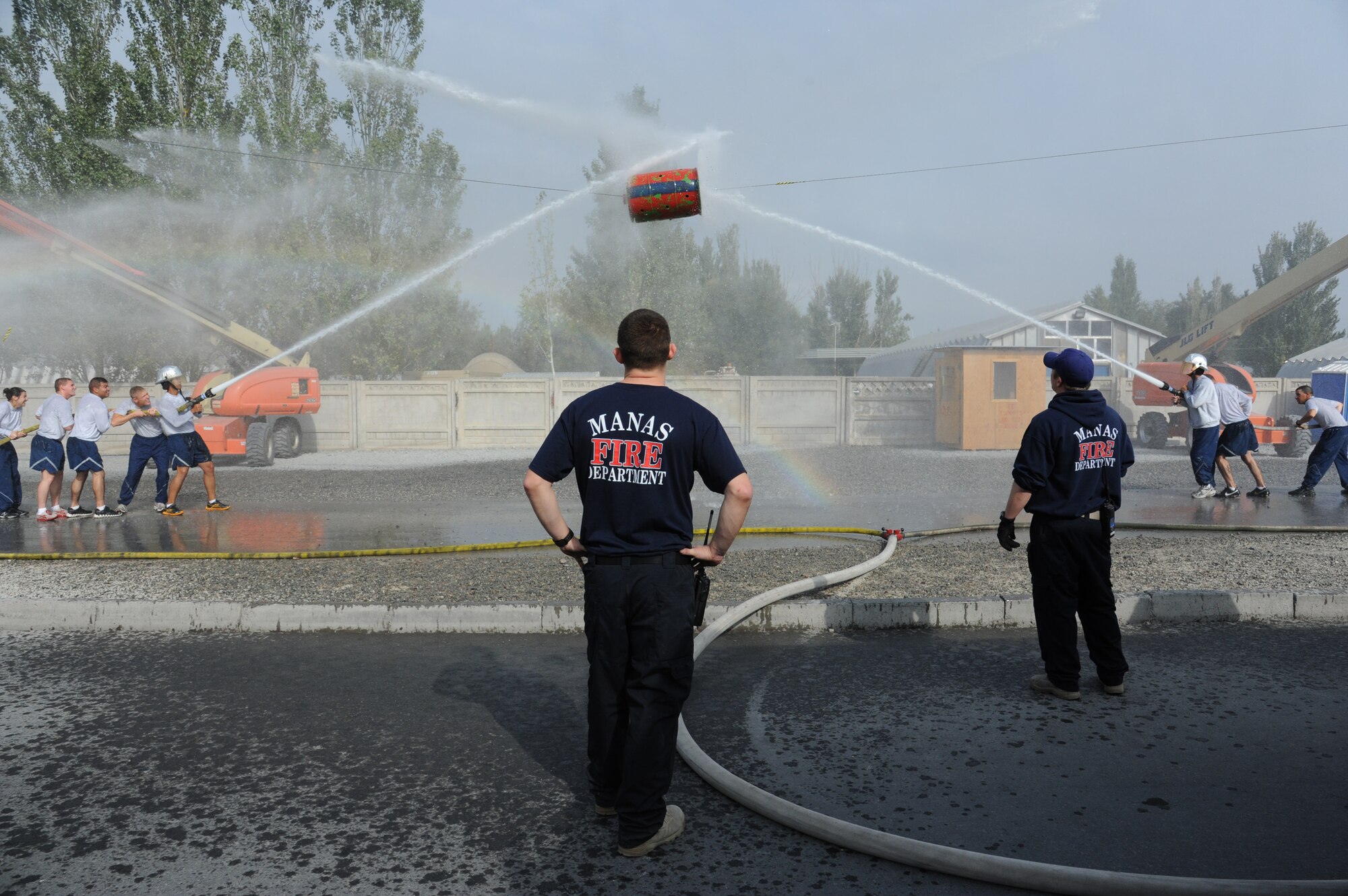 The two top teams from the 2011 Firefighter Challenge battle during a water joust event Oct. 15 at the Transit Center at Manas, Kyrgyzstan. The water joust pitted the civil engineers “Team Thundercat” against “Team RED HORSE”--the civil engineers took the best two out of three attempts. The winning team members each received $50 and a Manas Fire Department T-shirt.  According to Transit Center Fire Chief George Parker, “Although the civil engineers did win outright with a time of 11:46:03, the time had been reduced to 11:16:03 because they won the water joust. The joust cut 30 seconds off the original Firefighter Challenge time. RED HORSE came in second with a time of 11:46:56. It was an even match and the closest in the past four years.” (U.S. Air Force photo/Maj. Bob Everdeen)