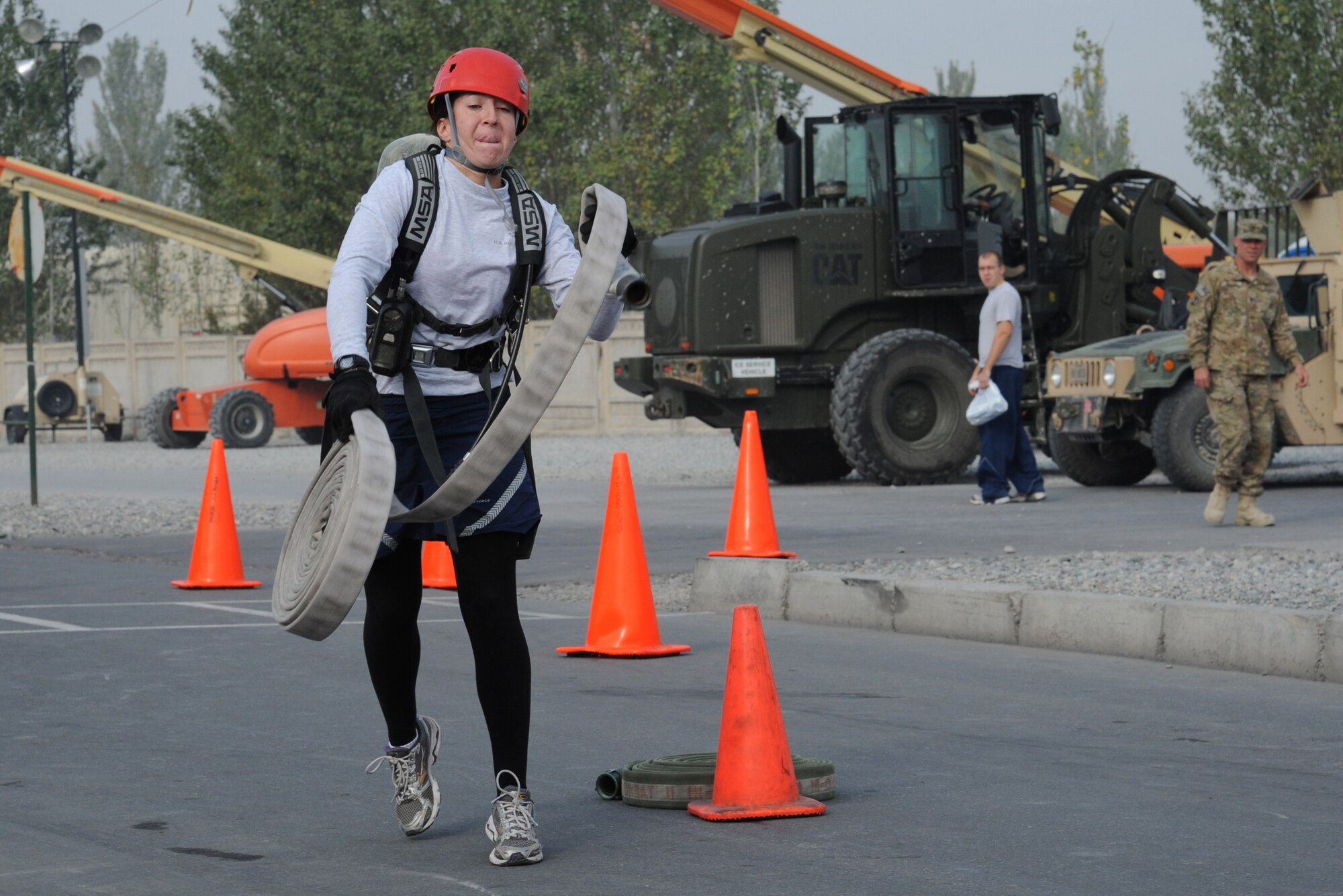 Staff Sgt. Danielle Cupp, a 376th Expeditionary Security Forces Squadron defender, heaves a coiled fire hose Oct. 15 during the 2011 Firefighter Challenge at the Transit Center at Manas, Kyrgyzstan. Cupp was one member of the five-person ESFS team that competed against other units here, which included Civil Engineers, the Operations Group, Red Horse and Contracting.  The Firefighter Challenge included various tests of strength and skill and was the wrap-up for this year's Fire Prevention Week here. Cupp is deployed from McConnell Air Force Base, Kan. (U.S. Air Force photo/Maj. Bob Everdeen)