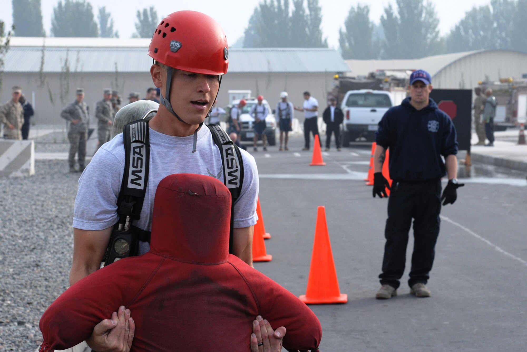 Capt. Eric Omundson of "Team RED HORSE" drags a 160-pound dummy during the 2011 Firefighter Challenge Oct. 15 at the Transit Center at Manas, Kyrgyzstan. The challenge was the final event in this year's Fire Prevention Week here and was an opportunity for several different teams and dozens of spectators to participate in a friendly competition of strength and skill. Appropriately, the Firefighter Challenge was held in front of Pete’s Place, the all-ranks recreation facility named after New York City Fire Chief Peter Ganci, Jr. who was killed during the terrorist attacks on Sept. 11, 2001. Team RED HORSE took second place in the event with a combined team time of 11:46:56. Omundson is deployed as the RED HORSE Manas site officer in charge from Nellis Air Force Base, Nev. He is a native of Iowa City, Iowa. (U.S. Air Force photo/Maj. Bob Everdeen)