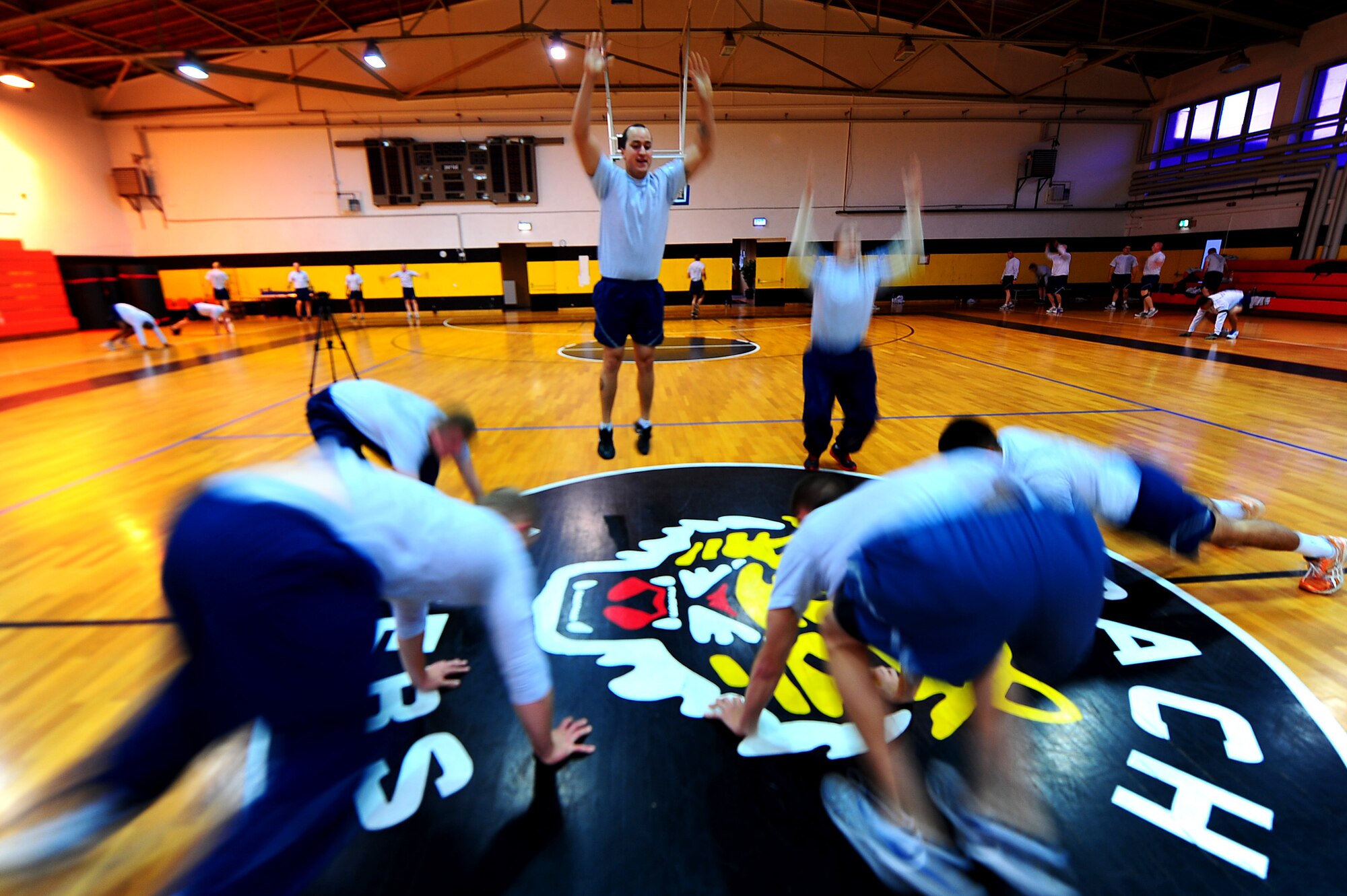 Air Force security forces personnel from the 435th Security Forces Squadron, 569th SFS and 52nd SFS, perform burpees during a memorial workout, Sembach Kaserne, Germany, Oct. 14, 2011. The workout was in honor of Airman 1st Class LeeBernard Chavis, a fallen member of the 824th Security Forces Squadron, Moody Air Force Base, Ga.; it consisted of 150 burpees, a one mile run and 150 squat thrusters. (U.S. Air Force photo by Airman 1st Class Brea Miller)