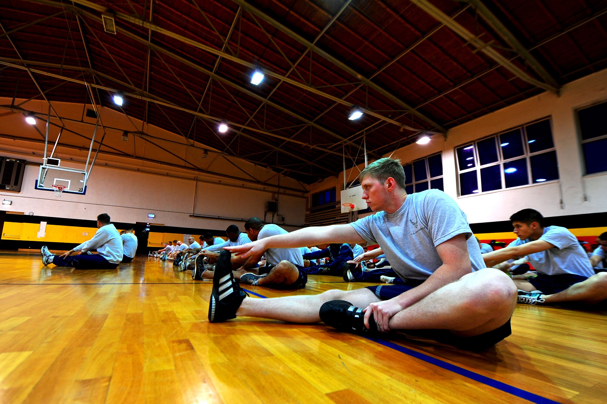 Air Force security forces personnel from the 435th Security Forces Squadron, 569th SFS and 52nd SFS, stretch before conducting a memorial workout, Sembach Kaserne, Germany, Oct. 14, 2011. The workout was in honor of Airman 1st Class LeeBernard Chavis, a fallen member of the 824th Security Forces Squadron, Moody Air Force Base, Ga.; it consisted of 150 burpees, a one mile run and 150 squat thrusters. (U.S. Air Force photo by Airman 1st Class Brea Miller)
