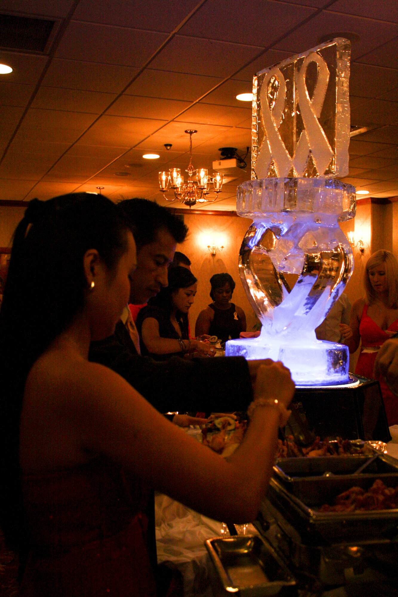 Attendees dine in elegance at the Pink Dress and Purple Tie Gala in the Rocker NCO Club on Kadena Air Base, Japan, Oct. 7. In addition to a wide buffet selection, guests also enjoyed a chocolate fountain, meat carving station and drinks during the gala. (U.S. Air Force photo/2nd Lt. Hope Cronin/Released)