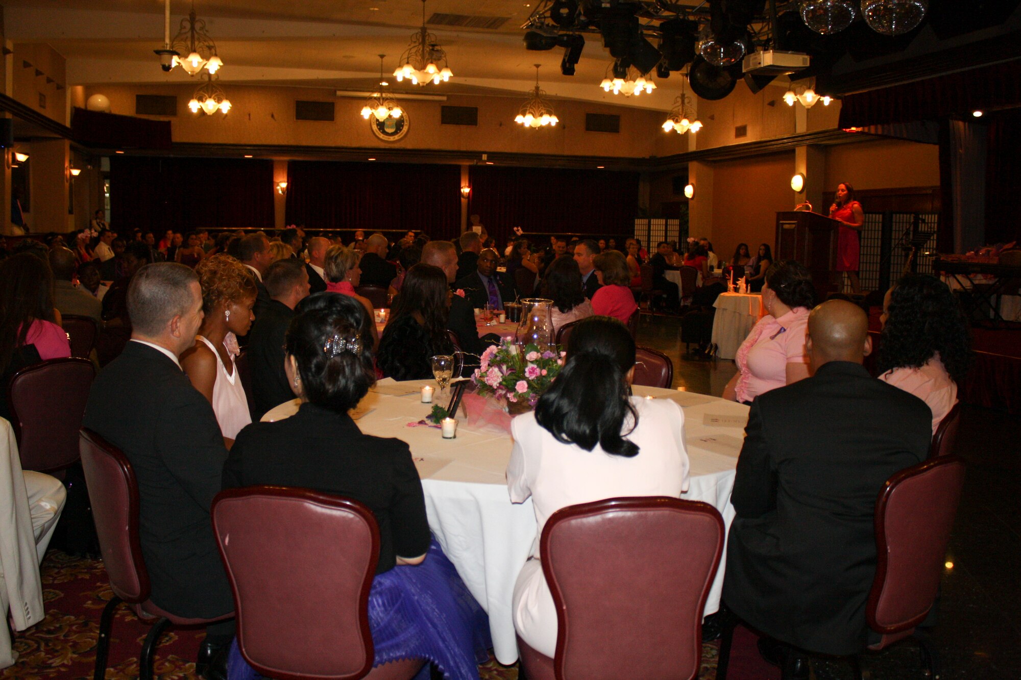 Guests attend the Pink Dress and Purple Tie Gala to support breast cancer and domestic abuse awareness at the Rocker NCO Club on Kadena Air Base, Japan, Oct. 7. October is both breast cancer and domestic abuse awareness month. (U.S. Air Force photo/2nd Lt. Hope Cronin/Released)
