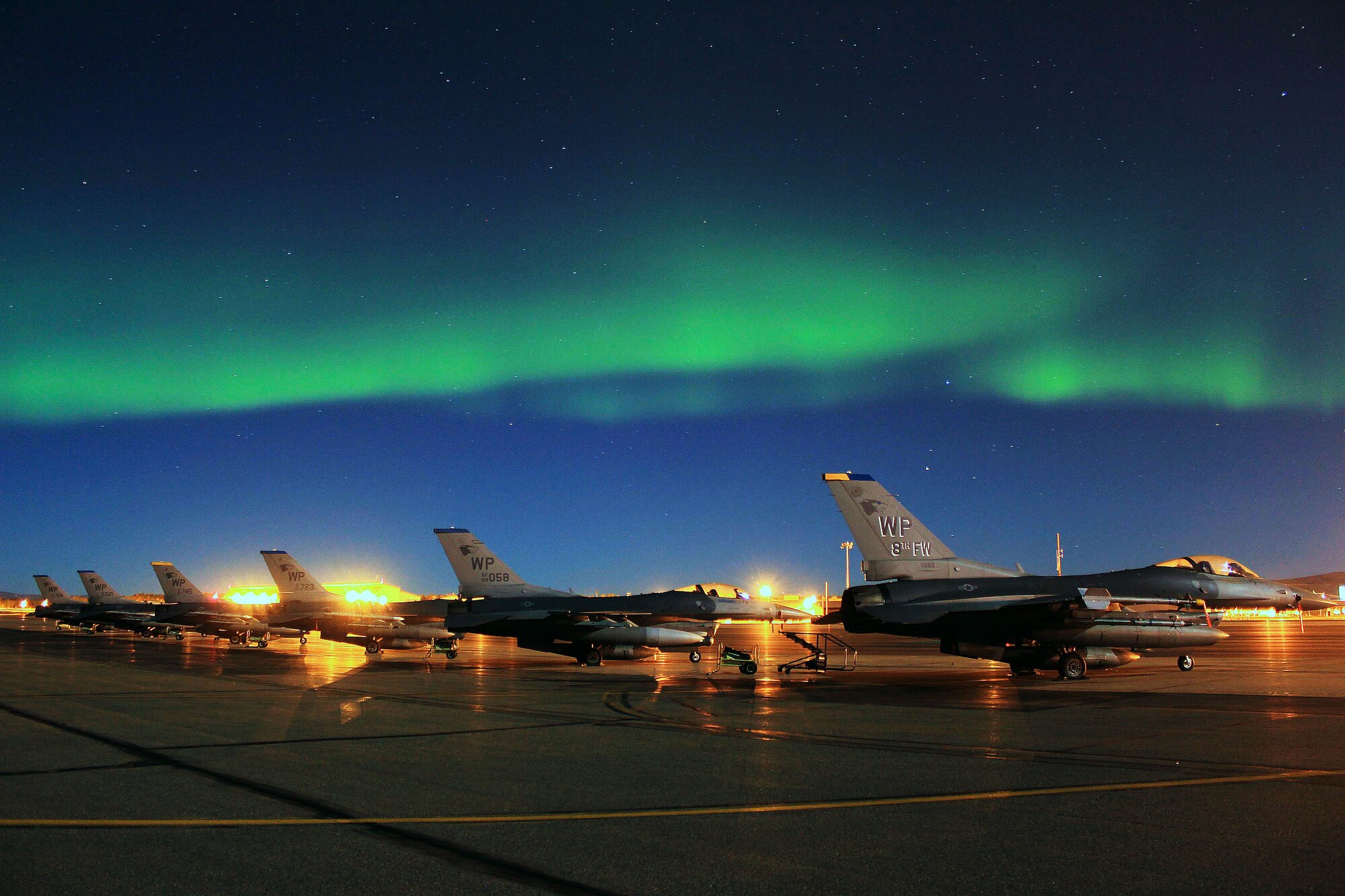 A row of F-16 Fighting Falcons of the 8th Fighter Wing deployed from Kunsan Air Base, Republic of Korea, sit mission-ready during Red Flag Alaska 11-3 at Eielson Air Force Base, Alaska, Sept. 14, 2011. RFA is a realistic 10-day air combat training exercise designed to bring Airmen together from all different platforms and backgrounds to execute in a multi-service environment. (U.S. Air Force photo by Staff Sgt. Kurtis Hoar/Released)