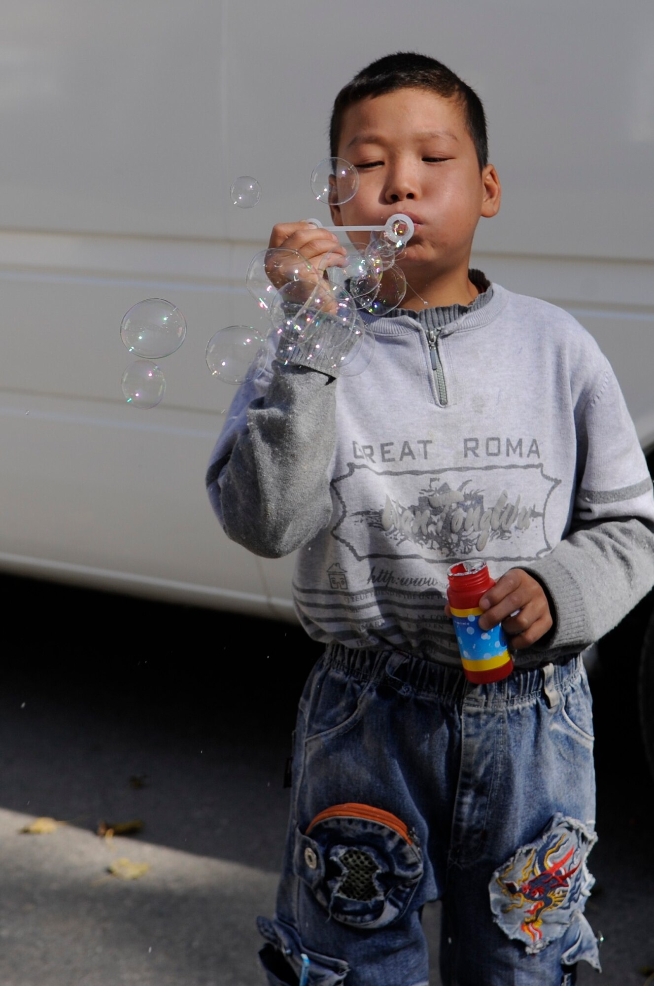 A boy plays with bubbles at the Nizhanchuisk Orphanage and School, Kyrgyzstan, Oct. 13. Manas Area Benefit Outreach Society Airmen visited the orphanage to paint, deliver donations and play with the children. MABOS is a private organization that provides gifts, goods and services to people or organizations in the area surrounding the Transit Center at Manas. MABOS was established in 2003. (U.S. Air Force photo/Tech. Sgt. Tammie Moore)