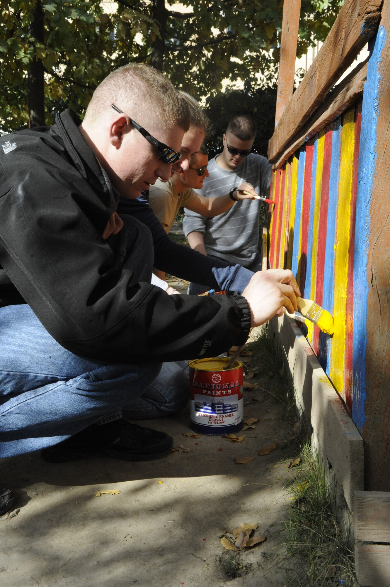 Airman 1st Class Mitchell Barnhouse paints a gazebo at the Nizhanchuisk Orphanage and School, Kyrgyzstan, Oct. 13. Barnhouse is a member of the Manas Area Benefit Outreach Society. MABOS was established in 2003 as a means for Airmen deployed to the Transit Center at Manas to aid organizations in the area surrounding the installation. Barnhouse is a 376th Expeditionary Security Forces Squadron patrolman deployed from Cheyenne Mountain, Colo. (U.S. Air Force photo/Tech. Sgt. Tammie Moore)