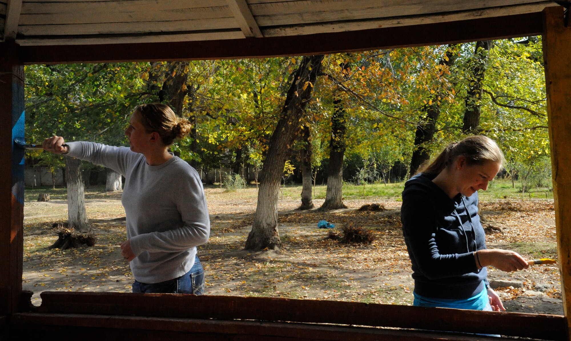Staff Sgt. Tina Talamantes (left) and Senior Airman April Stinton paint a gazebo at the Nizhanchuisk Orphanage and School, Kyrgyzstan, Oct. 13. Talamantes and Stinton are both Manas Area Benefit Outreach Society Nizhanchuisk Orphanage focus group leaders. Airmen at the Transit Center at Manas have donated more than 50,000 man-hours which have been invested to Kyrgyz organizations and charities through MABOS since 2003. The Airmen are both 376th Expeditionary Security Forces Squadron patrolmen. Talamantes, a native of Steeleville, Ill., is deployed from MacDill Air Force Base, Fla. Stinton, a native of Orlando, is deployed from Cheyenne Mountain, Colo. (U.S. Air Force photo/Tech. Sgt. Tammie Moore)