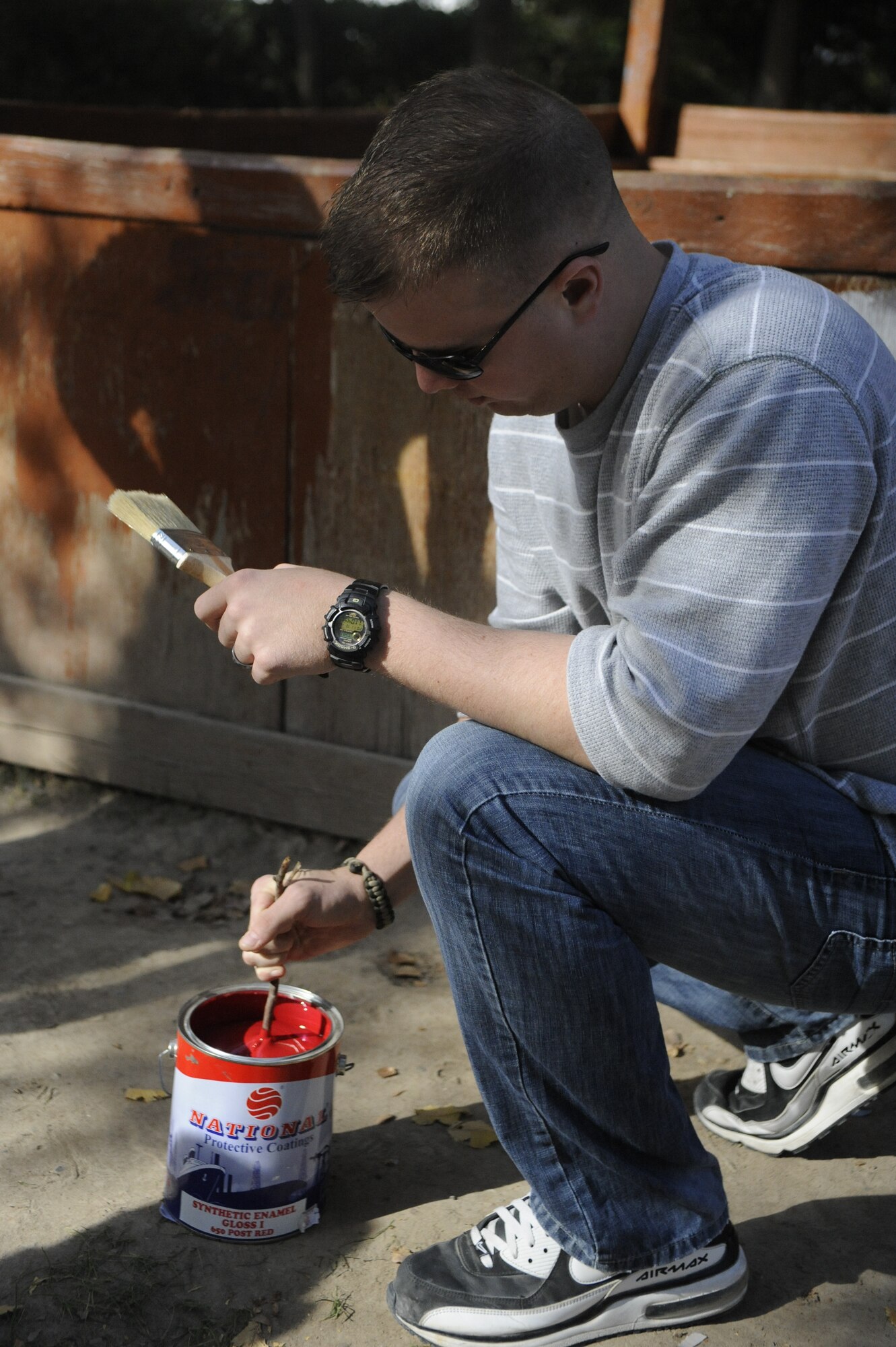 Airman 1st Class Joshua Spencer stirs paint at the Nizhanchuisk Orphanage and School Kyrgyzstan, Oct. 13. Spencer was one of six Manas Area Benefit Outreach Society Airmen who visited the orphanage to paint, deliver donations and play with the children. Spencer is a 376th Expeditionary Security Forces Squadron patrolman. He is deployed to the Transit Center at Manas from MacDill Air Force Base, Fla. (U.S. Air Force photo/Tech. Sgt. Tammie Moore)