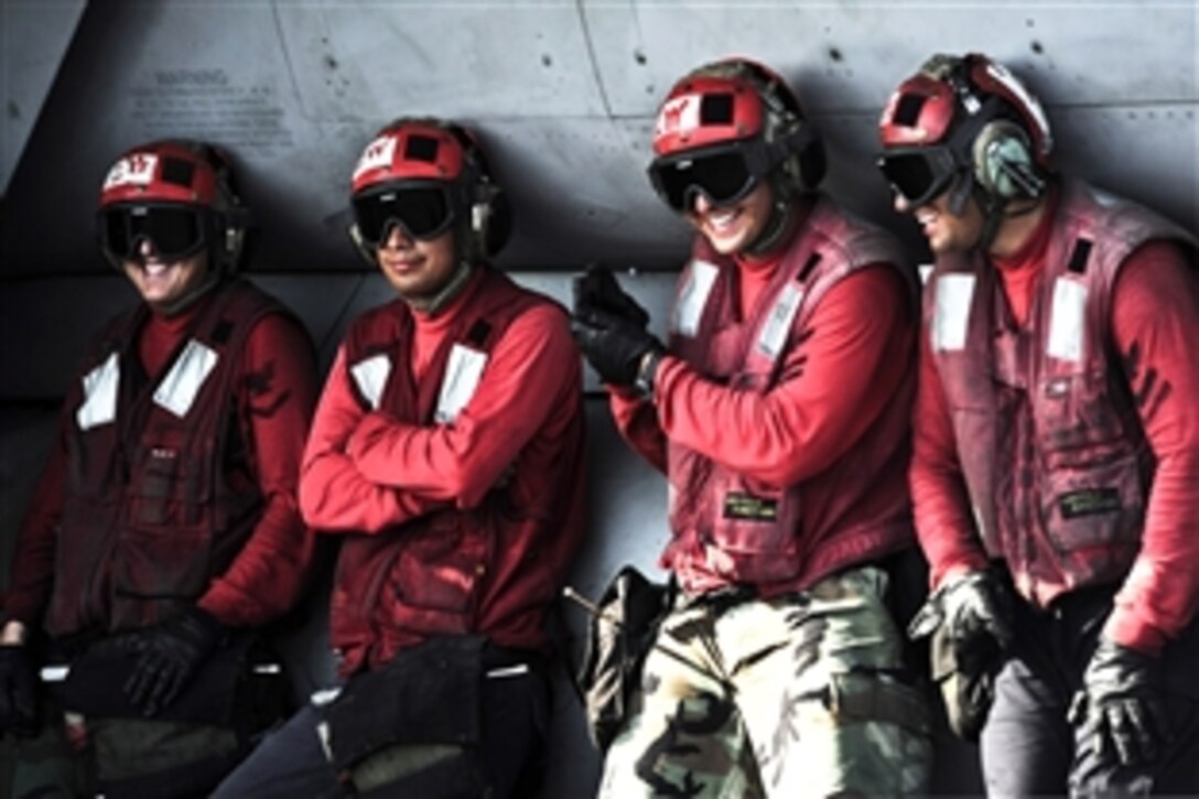 U.S. sailors share a laugh aboard the aircraft carrier USS John C. Stennis during flight operations in the Arabian Sea, Oct. 12, 2011. The John C. Stennis is deployed to the U.S. 5th Fleet area of responsibility conducting maritime security operations and support missions as part of operations Enduring Freedom and New Dawn.