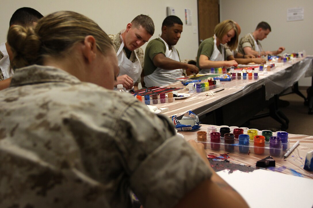 Marines paint canvases during a Art 4 Healing class at Camp Pendleton's Behavioral and Deployment Health center, Oct. 17. The program is designed to support emotional healing through are and creative expression for those living with pain, grief, fear or stress.