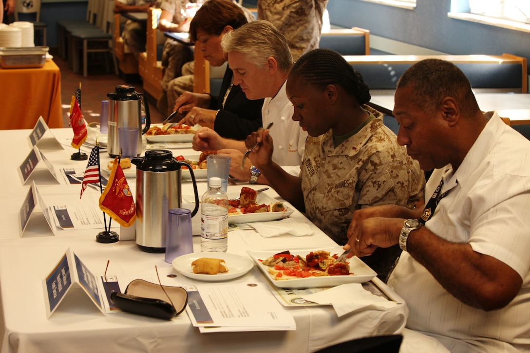 A panel of judges feast on dishes cooked by Marine and civilian food service specialists who participated in the third quarter Culinary Team of the Quarter Competition at Mess Hall 411 aboard Marine Corps Base Camp Lejeune, Oct. 18.