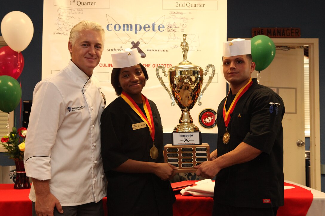 Mark Allison, the dean of culinary arts at the Charlotte campus for Johnson and Wales University, stands alongside Lance Cpl. Charmaine Jacksonv and Cpl. Frank Cala after they won the pasta-themed third quarter Culinary Team of the Quarter competition at Mess Hall 411 abaord Marine Corps Base Camp Lejeune, Oct. 18.