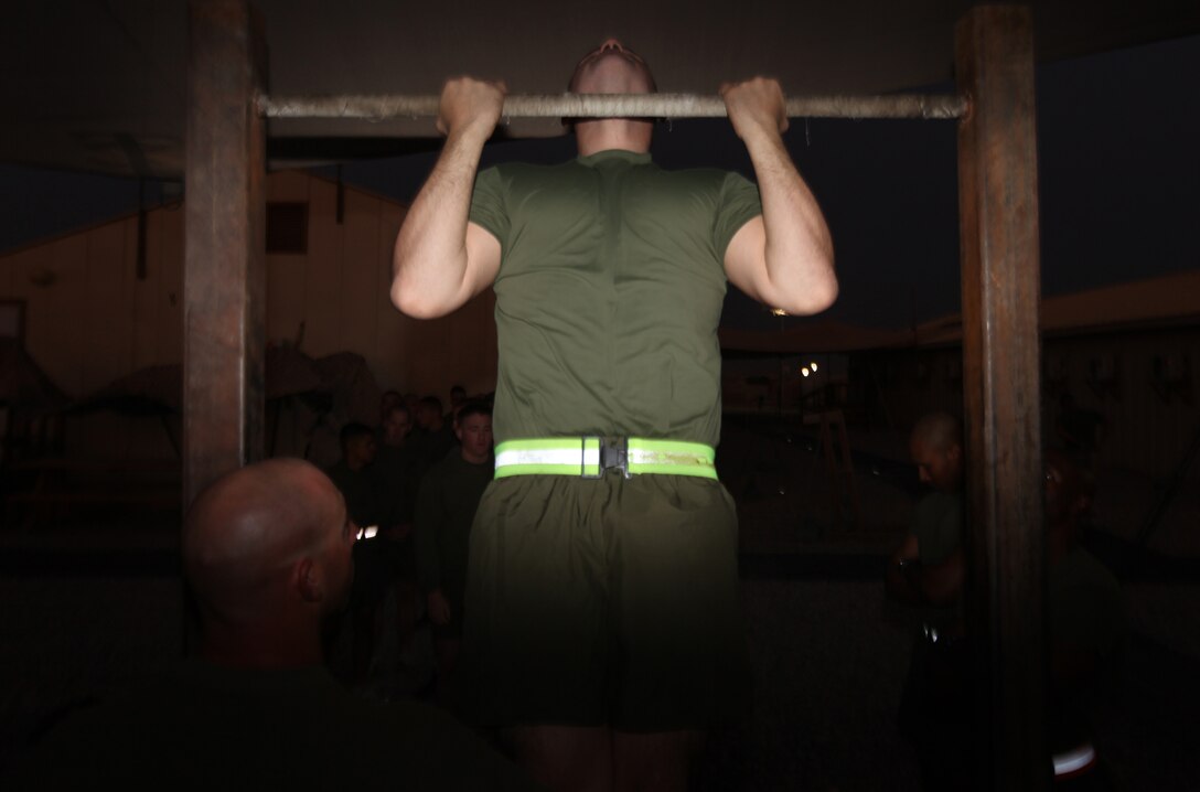 Cpl. Jordan Mannor, a data network specialist with Marine Air-Ground Task Force Support Battalion 11.2, 2nd Marine Logistics Group (Forward), inches his chin over the bar as he completes his 16th pull-up aboard Camp Leatherneck, Afghanistan, Oct. 18. Approximately 30 corporals took their initial physical fitness test as students of the 2nd MLG (FWD) Corporal’s Course. (U.S. Marine Corps photo by Sgt. Justin J. Shemanski)