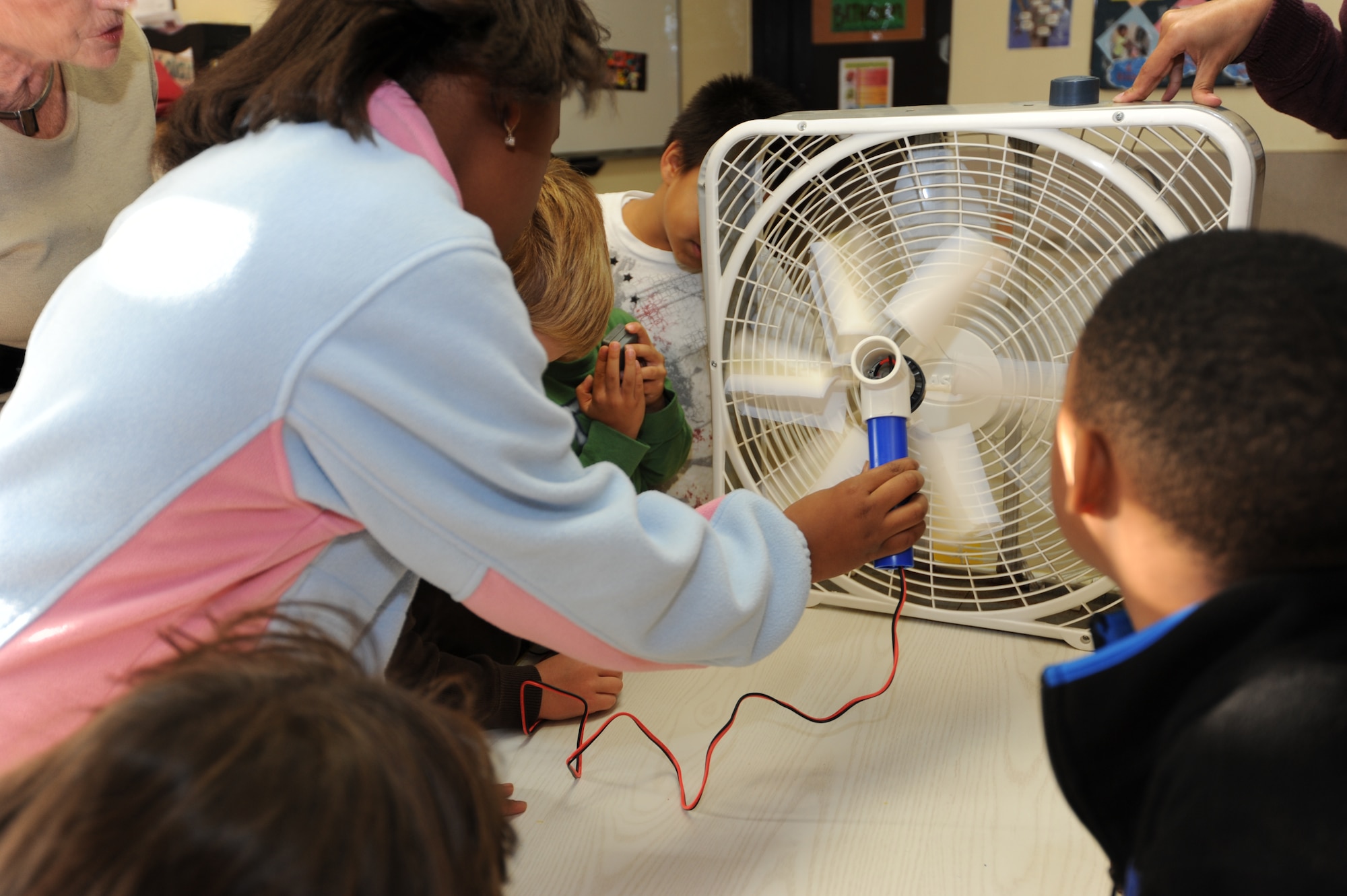 MISAWA AIR BASE, Japan -- Children from the Cheli School Age Program test their windmills for the 'Wired for Wind' project during Federal Energy Awareness month here Oct. 18. 'Wired for Wind' is an in-depth look at renewable energy technologies in the form of wind power. (U.S. Air Force photo by Airman 1st Class Kia Atkins)