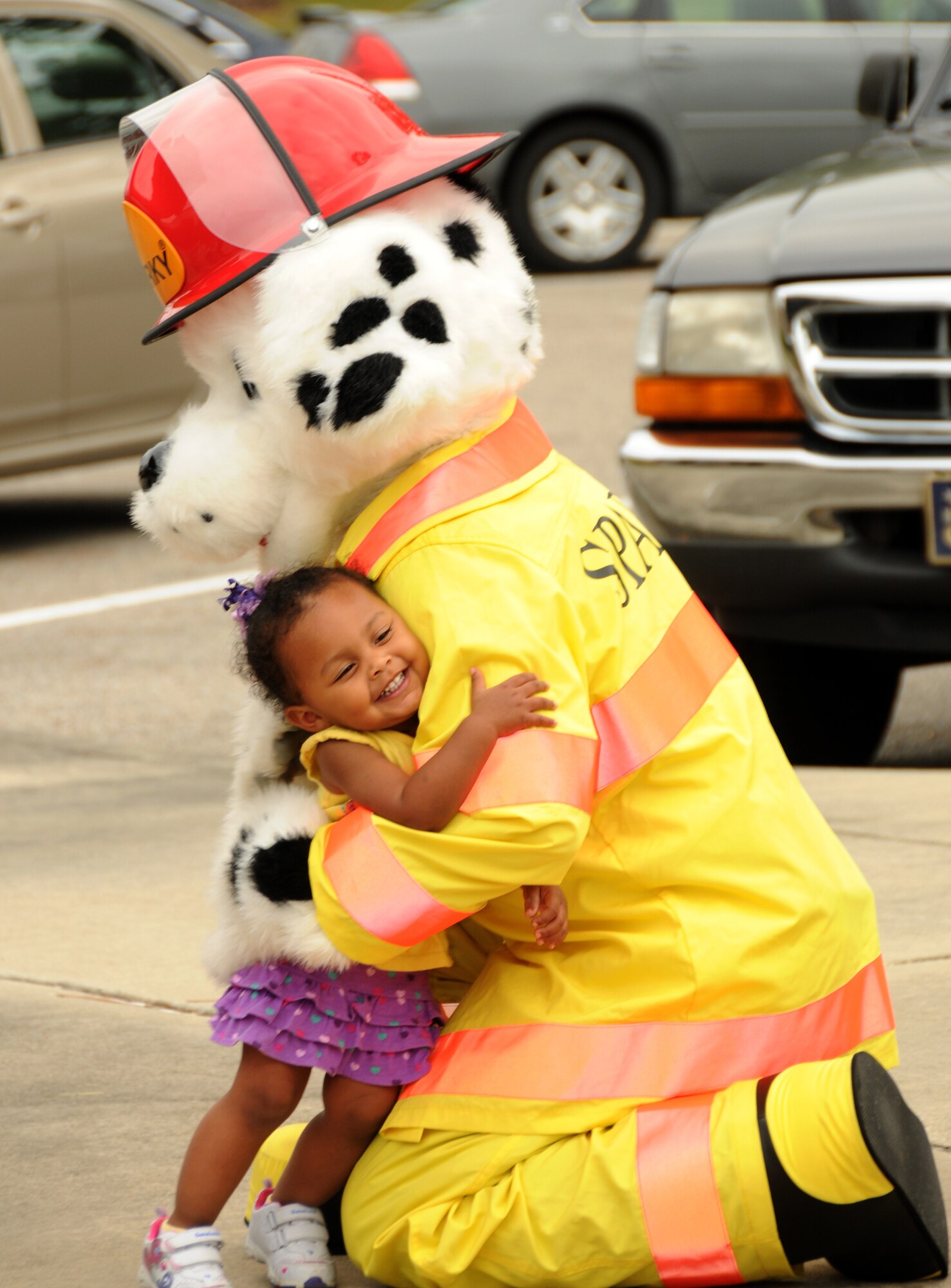 Tytiana McMillan, 2, gives a warm greeting to Sparky the fire dog during a visit from the Keesler fire Department to the Child Development Center at Keesler Air Force Base, Miss., Oct. 12, 2011.  Fire Prevention week was held Oct. 11-15.  Tytiana’s parents are Staff Sgt. Fredrick McMillan, 209th Civil Engineer Squadron, Gulfport, Miss.,  and Hazel McMillan, 81st Force Support Squadron.  SSgt. McMillan is currently deployed to Iraq.  (U.S. Air Force photo by Kemberly Groue)