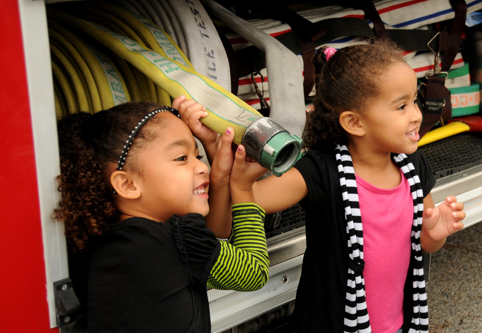 Tytiana McMillan, 2, gives a warm greeting to Sparky the fire dog during a visit from the Keesler fire Department to the Child Development Center at Keesler Air Force Base, Miss., Oct. 12, 2011.  Fire Prevention week was held Oct. 11-15.  Tytiana’s parents are Staff Sgt. Fredrick McMillan, 209th Civil Engineer Squadron, Gulfport, Miss.,  and Hazel McMillan, 81st Force Support Squadron.  SSgt. McMillan is currently deployed to Iraq.  (U.S. Air Force photo by Kemberly Groue)