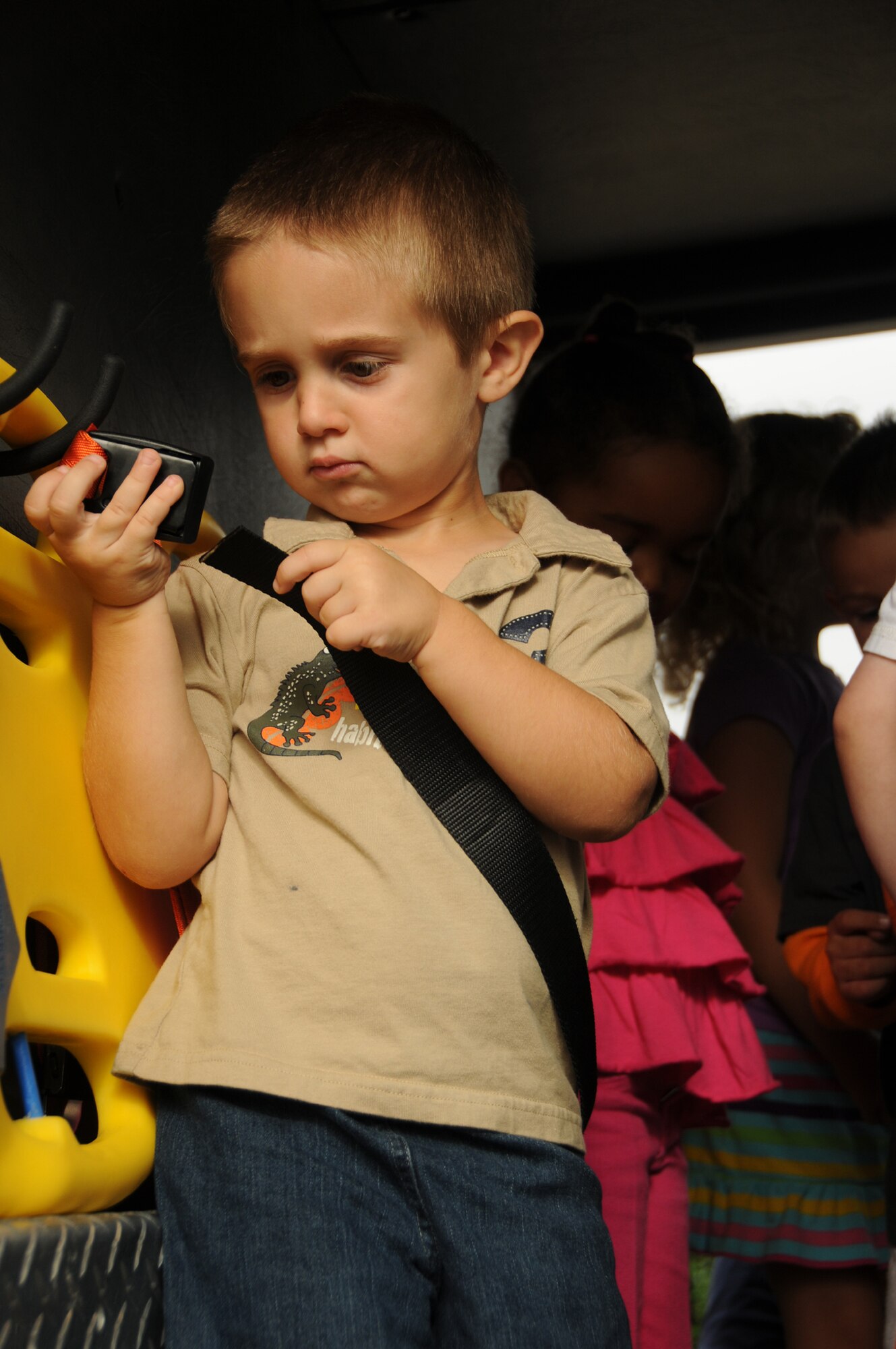 Jason Eudy, 3, son of Staff Sgt. Lillie Eudy, 81st Training Support Squadron, and Tech. Sgt. Michael Eudy, 333rd Training Squadron, tries to buckle himself in while touring the inside of a fire truck during a visit from the Keesler fire Department to the Child Development Center Oct. 12, 2011, at Keesler Air Force Base, Miss.  Fire Prevention week was held Oct. 11-15.  (U.S. Air Force photo by Kemberly Groue)